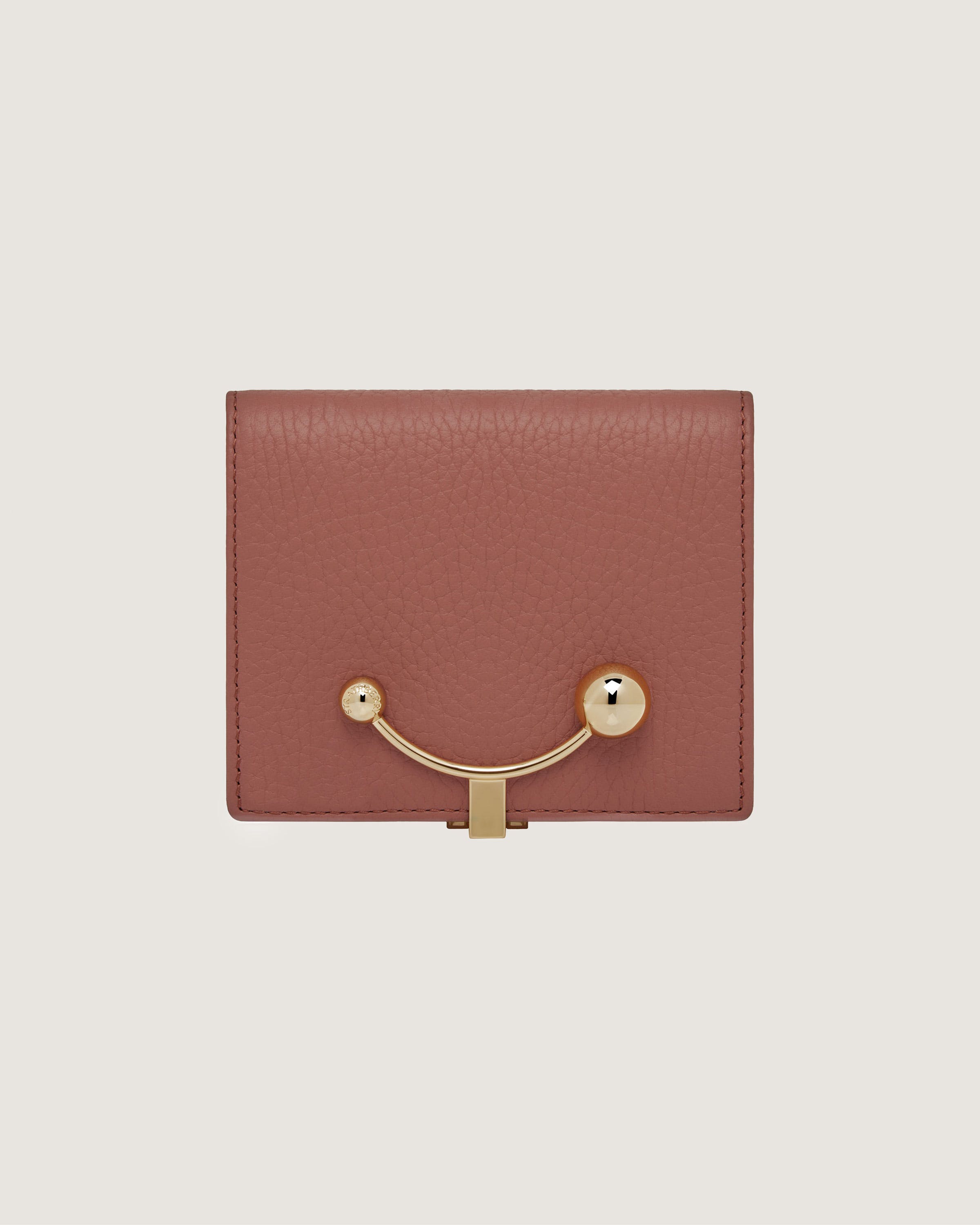 A brown wallet with a gold handle