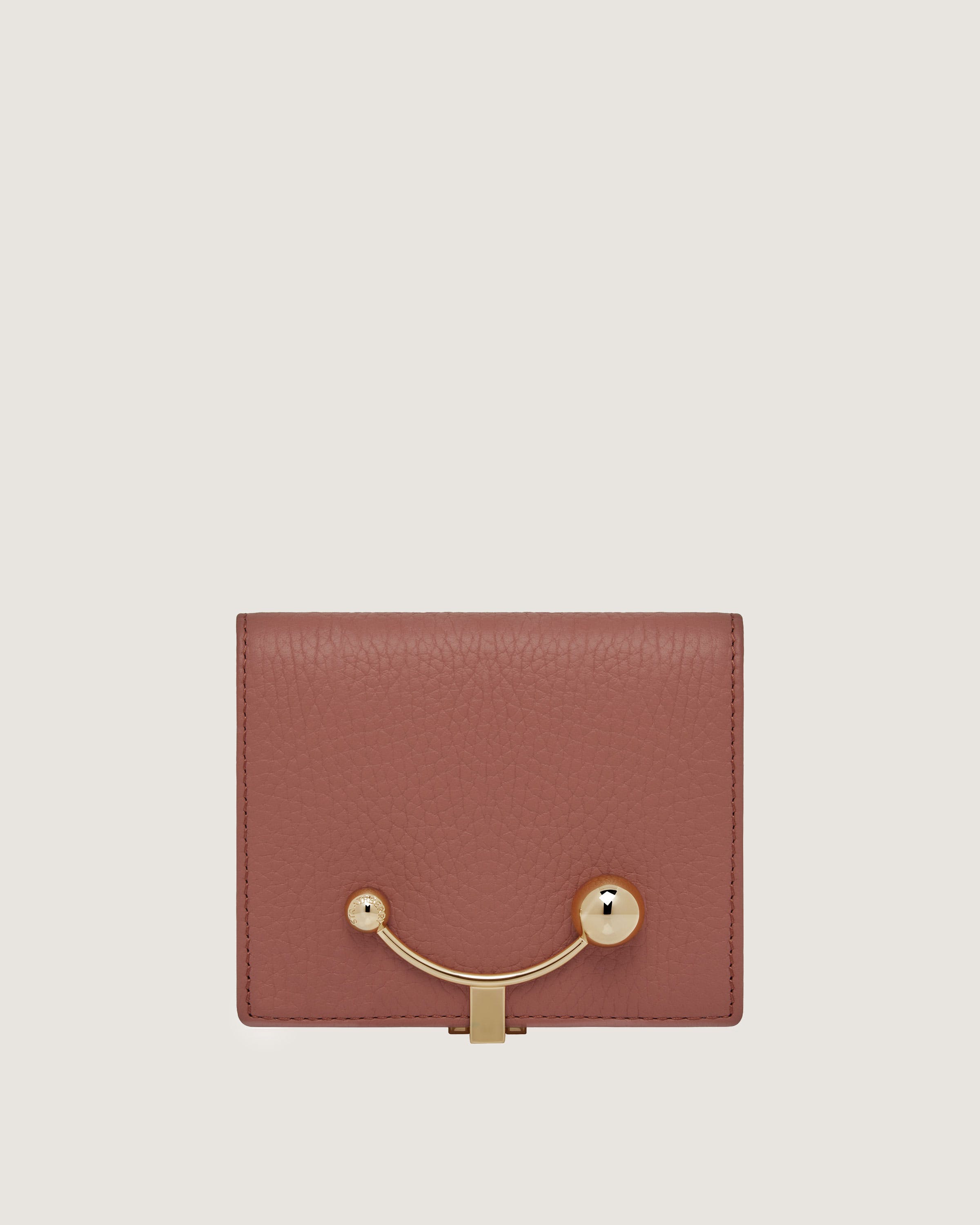 A brown wallet with a gold handle