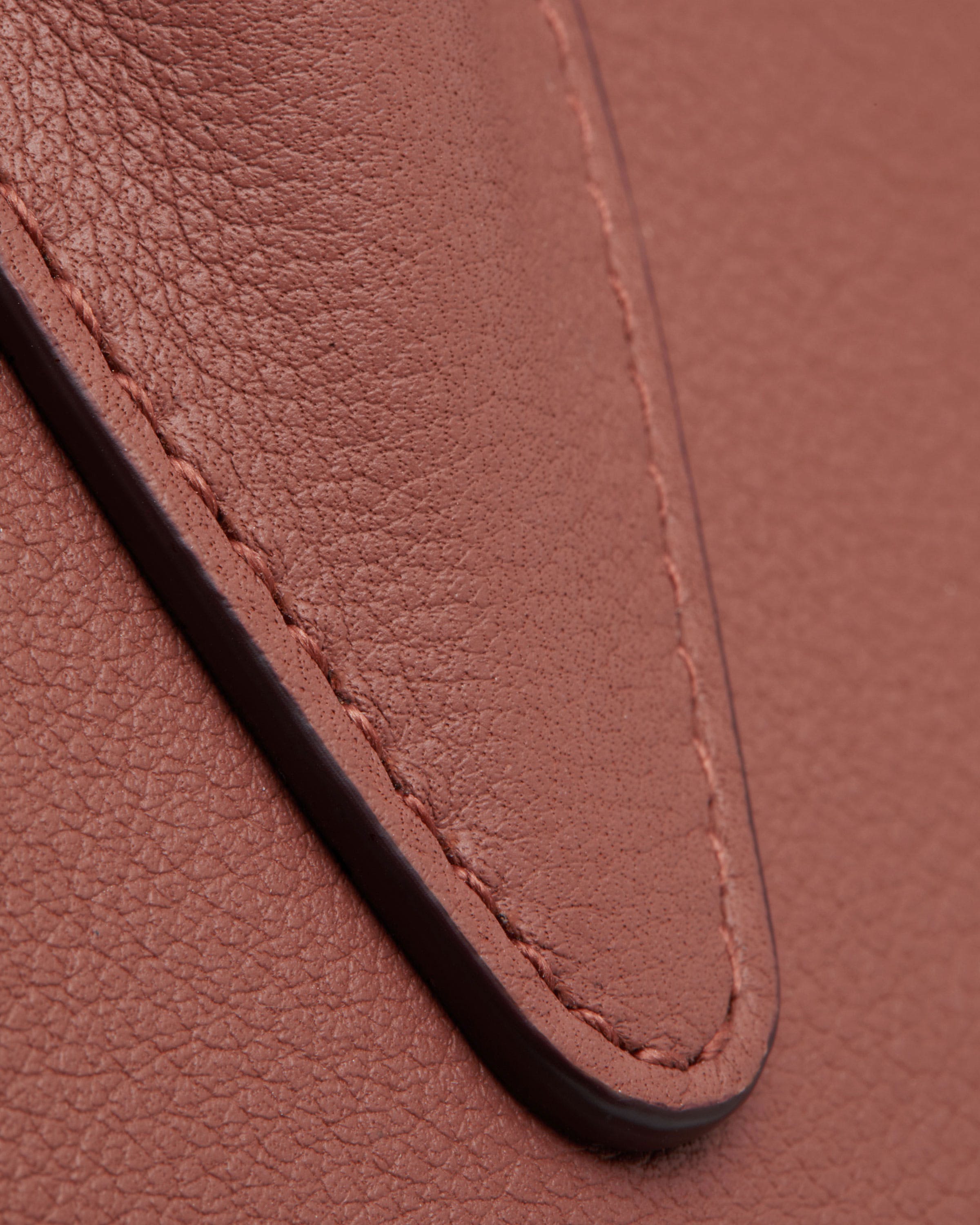 A close up of a brown leather bag