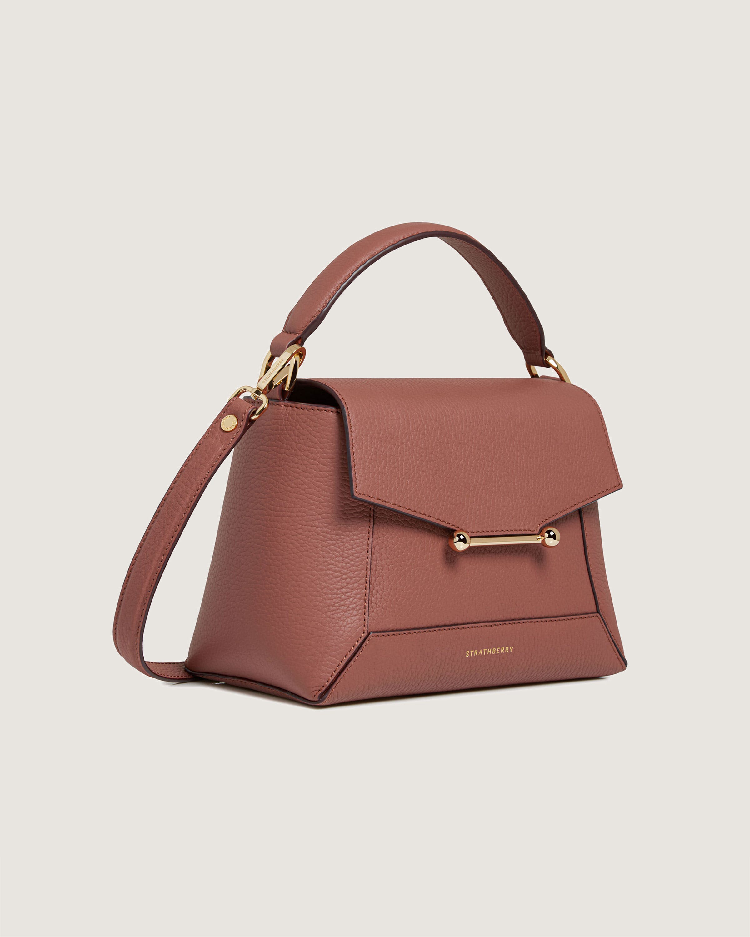 A brown handbag with a gold handle