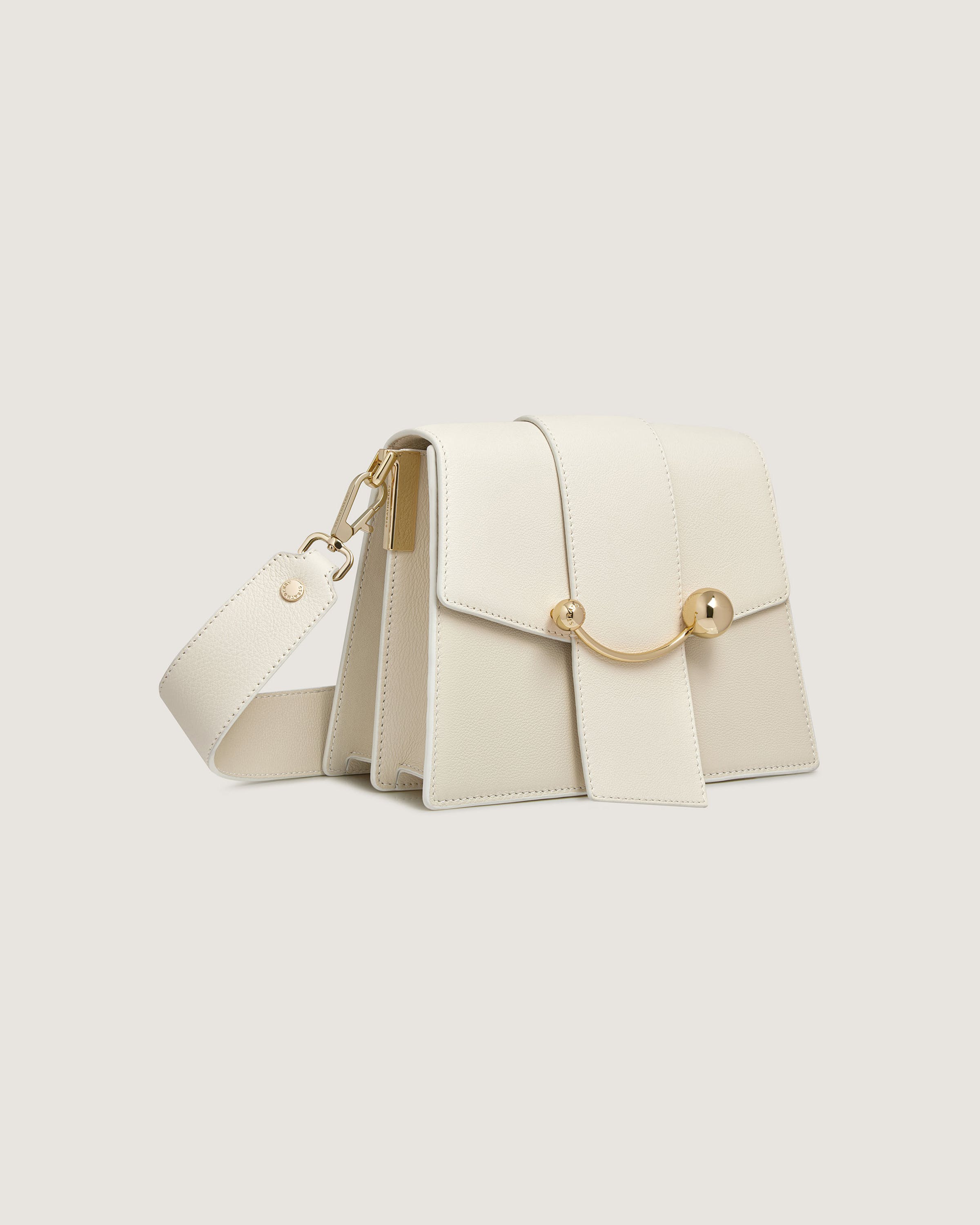 A white purse with a gold clasp