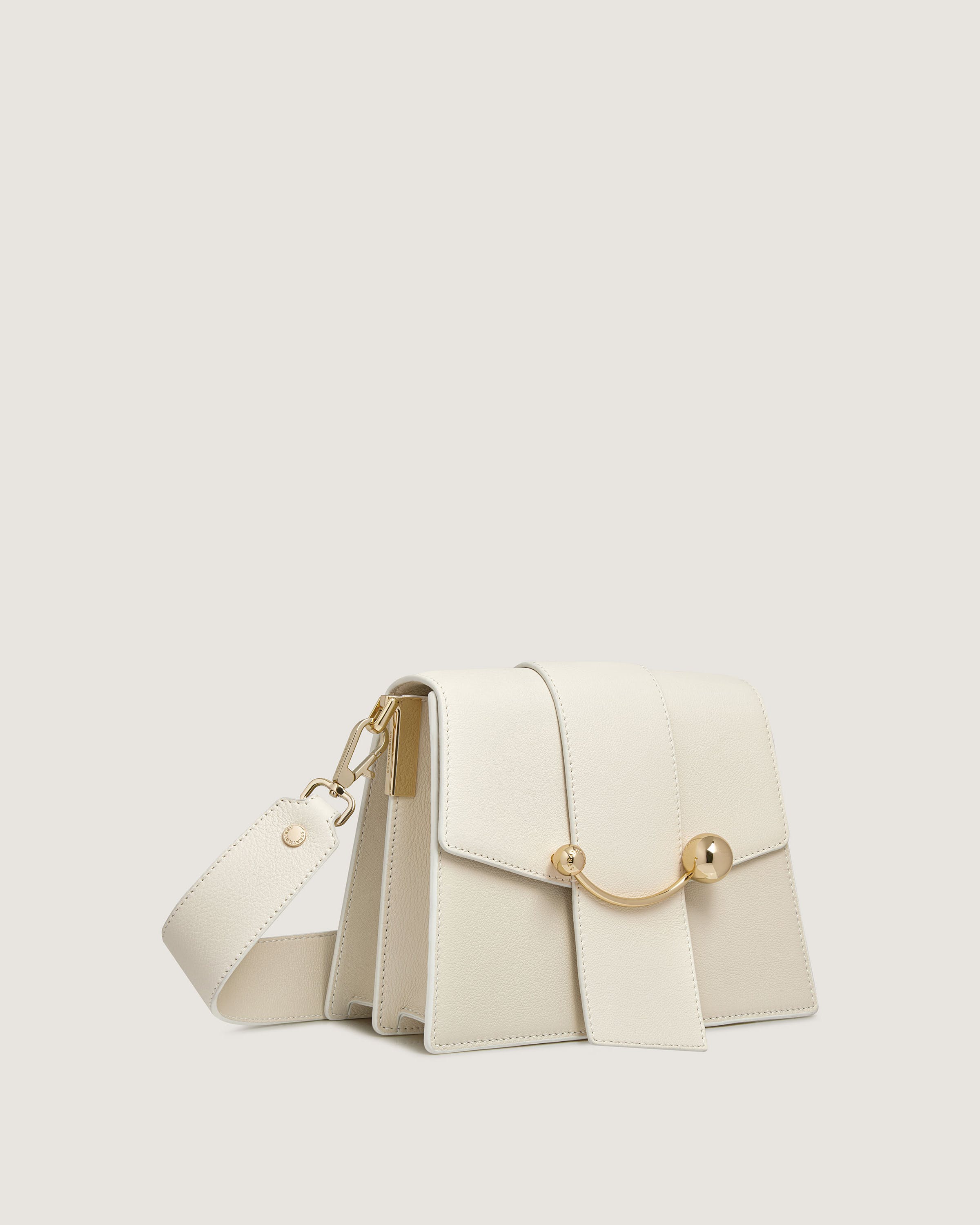 A white purse with a gold clasp