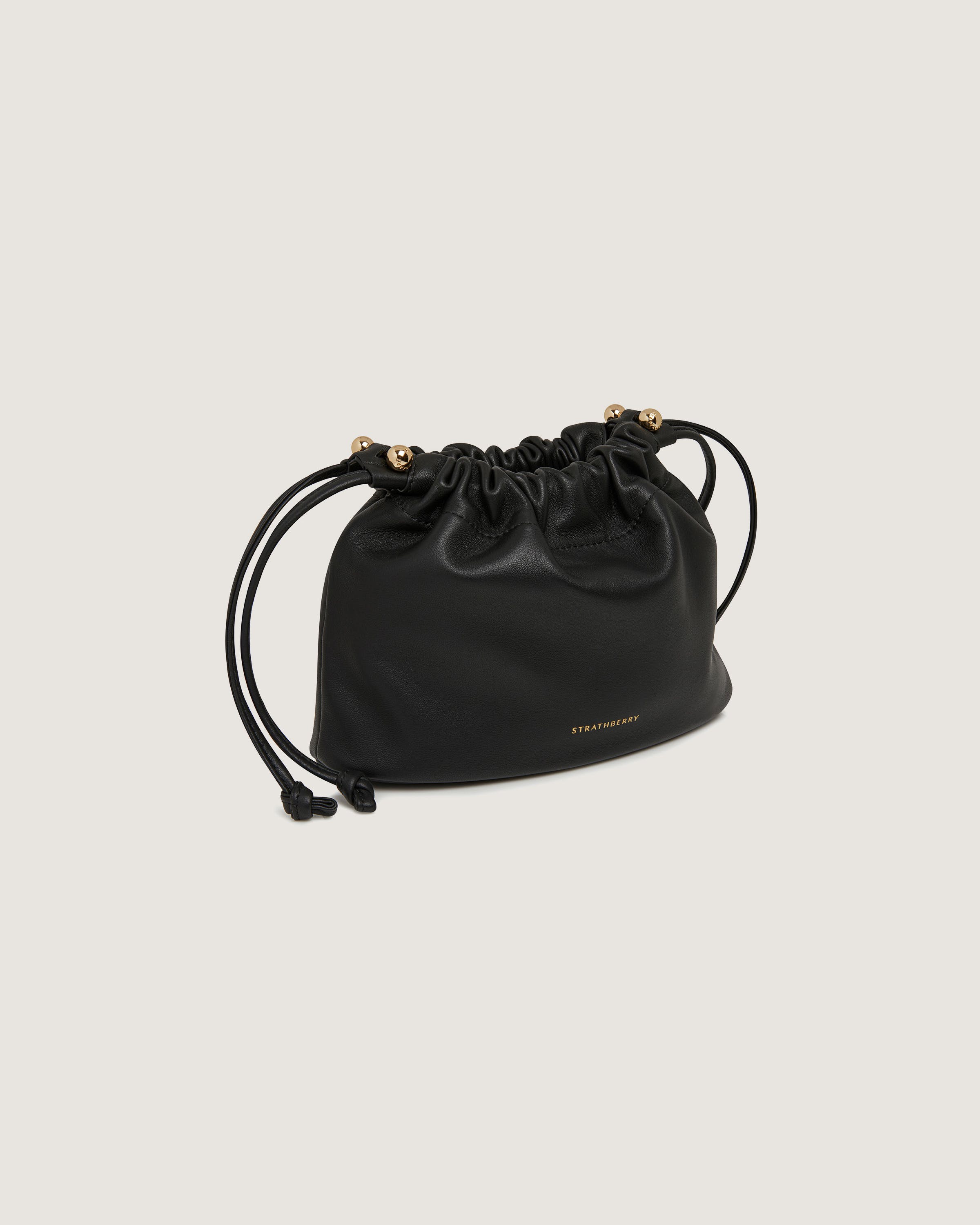 A black leather bag with gold hardwares