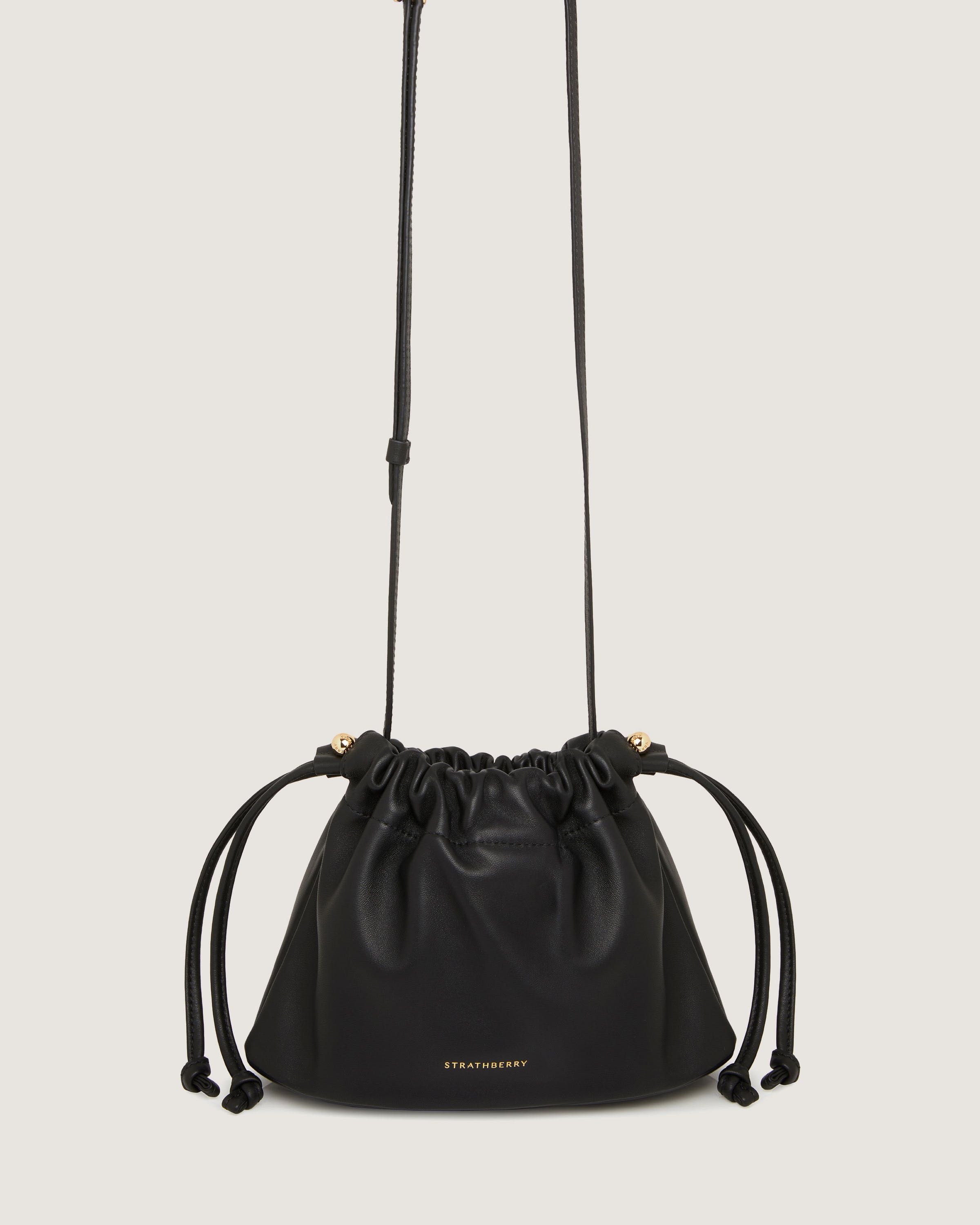 A black bucket bag with a drawstring strap