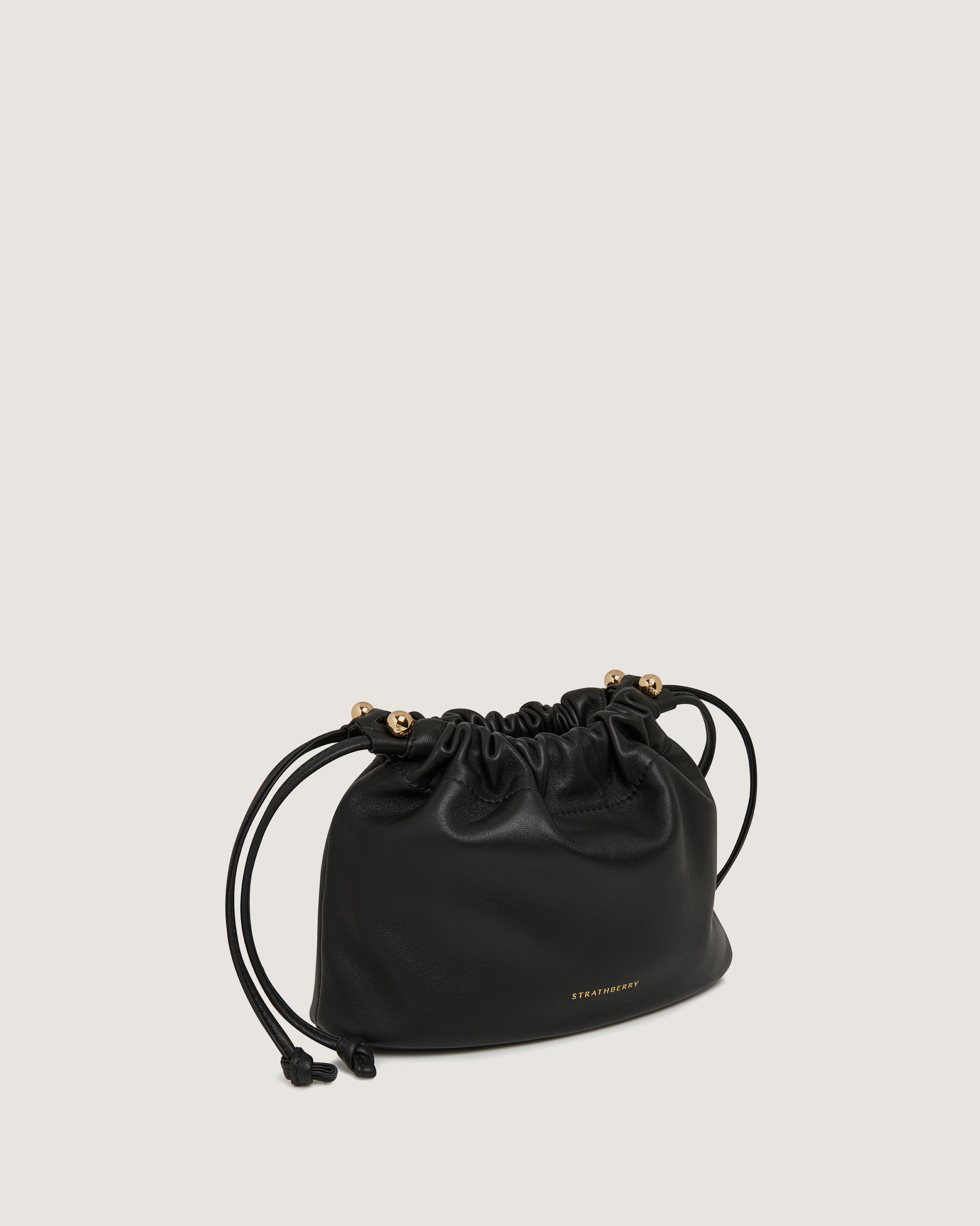 A black leather bag with gold hardwares