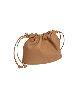 A tan leather bag with a drawstring strap