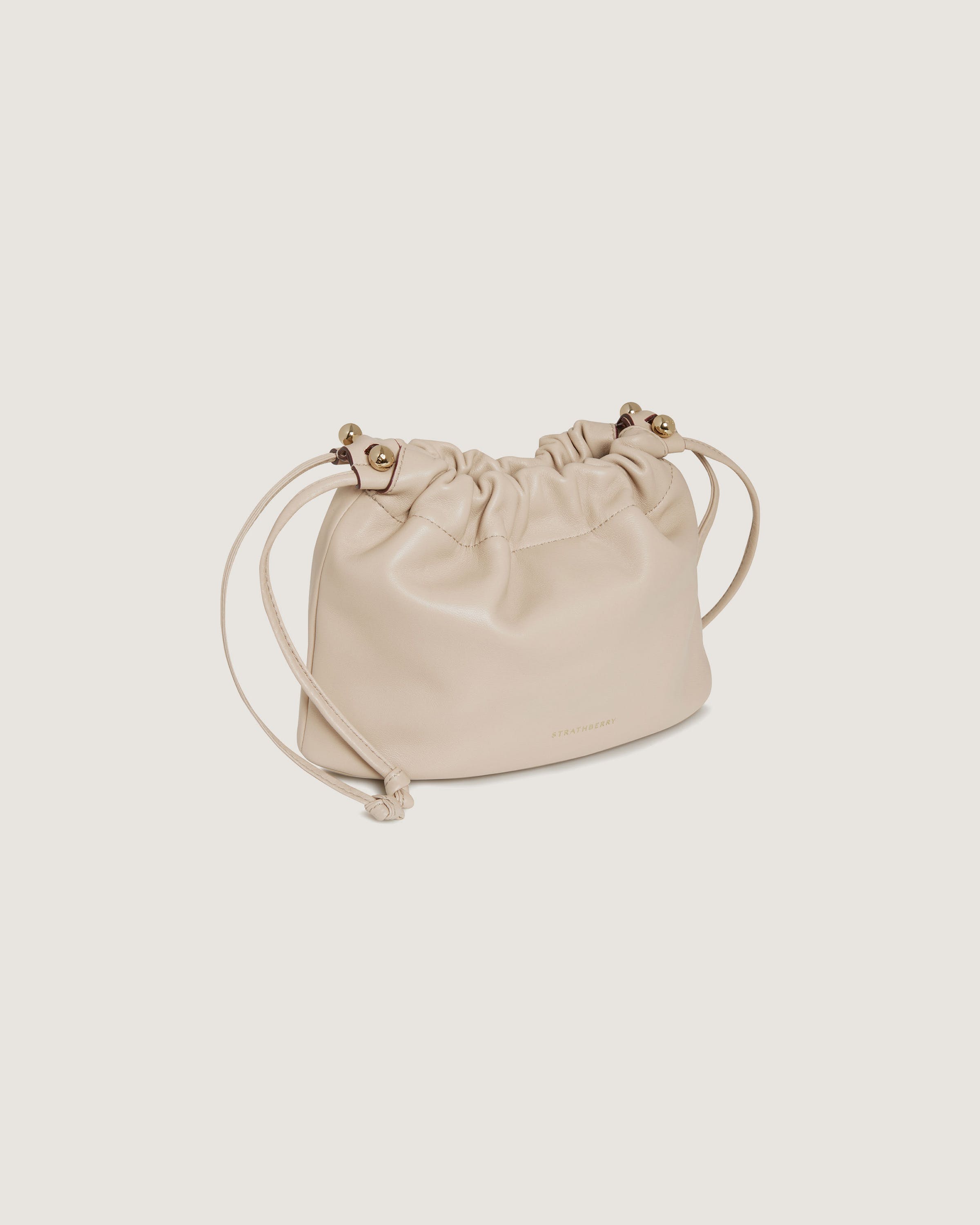 A white leather bag with a drawstring strap