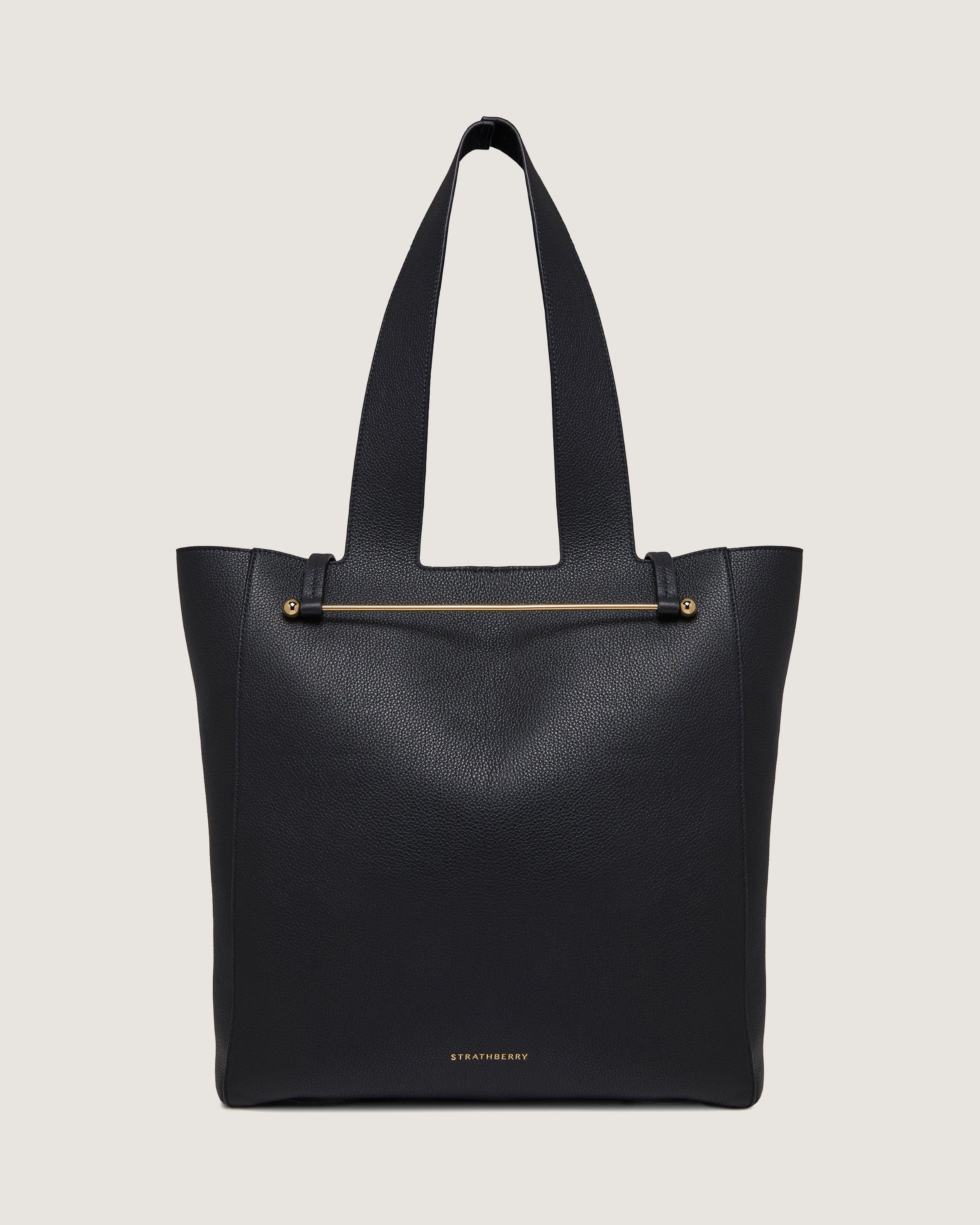 A black leather tote bag with zippers