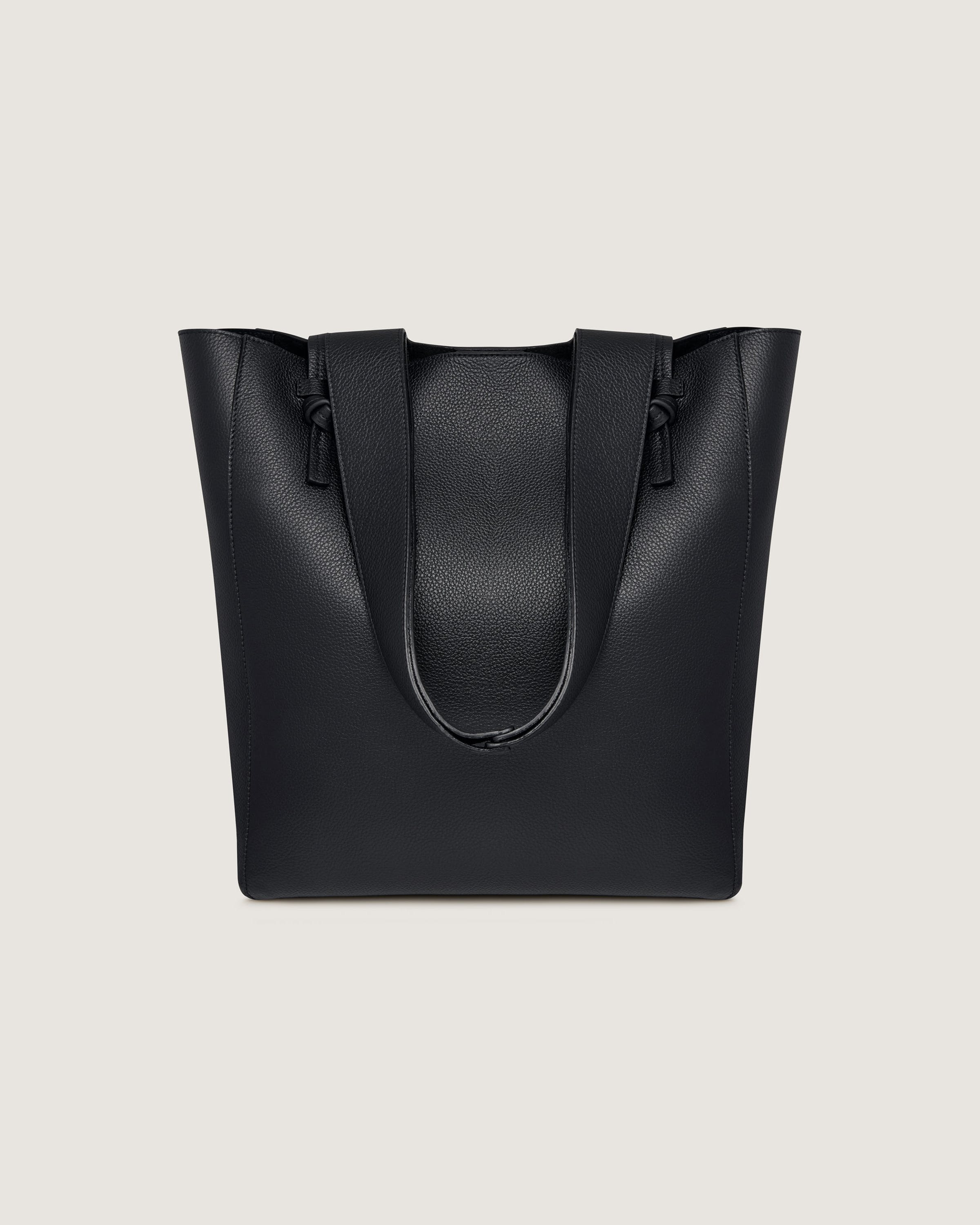 A black leather tote bag on a white background