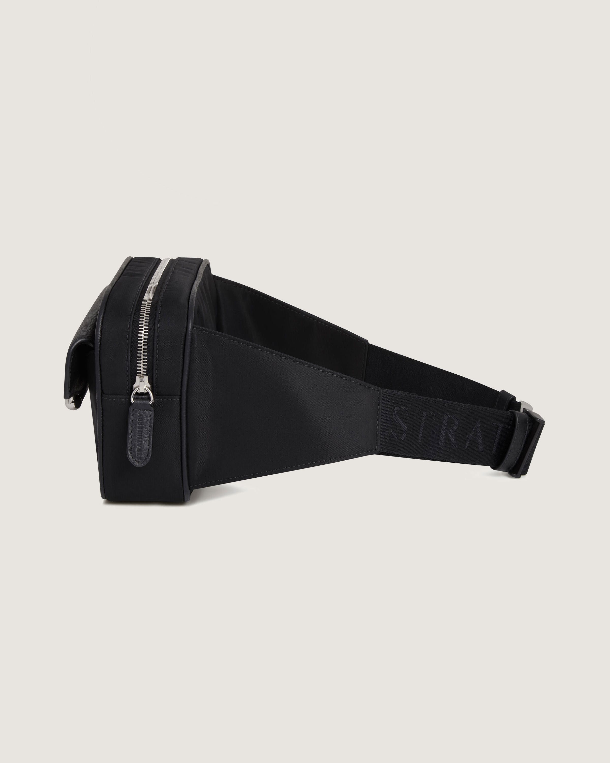 A black belt bag with a zipper on the side