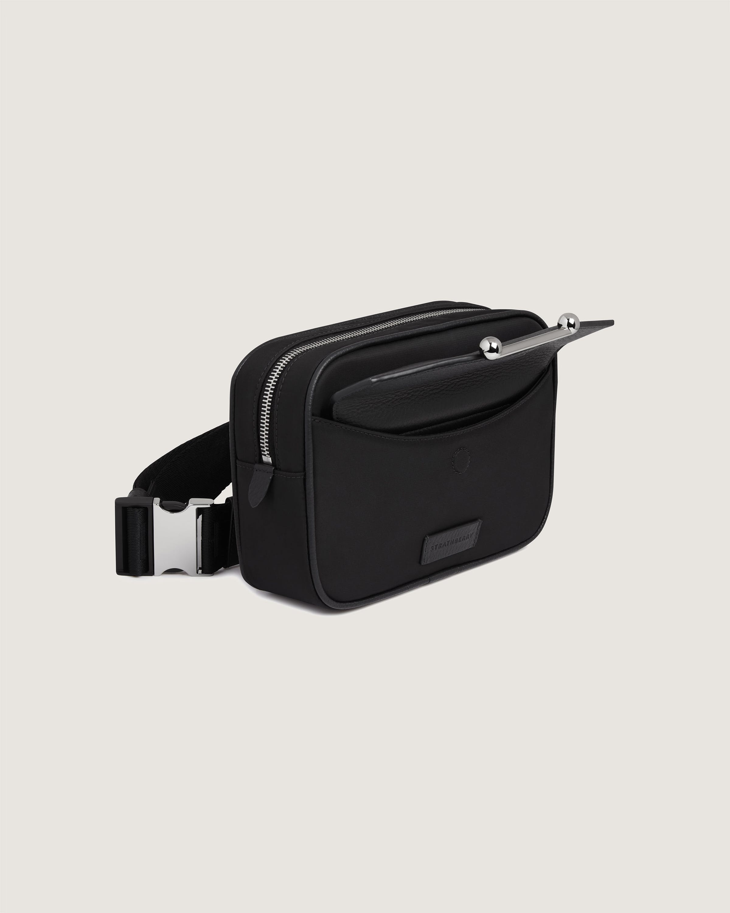 A black bag with a metal handle on a white background