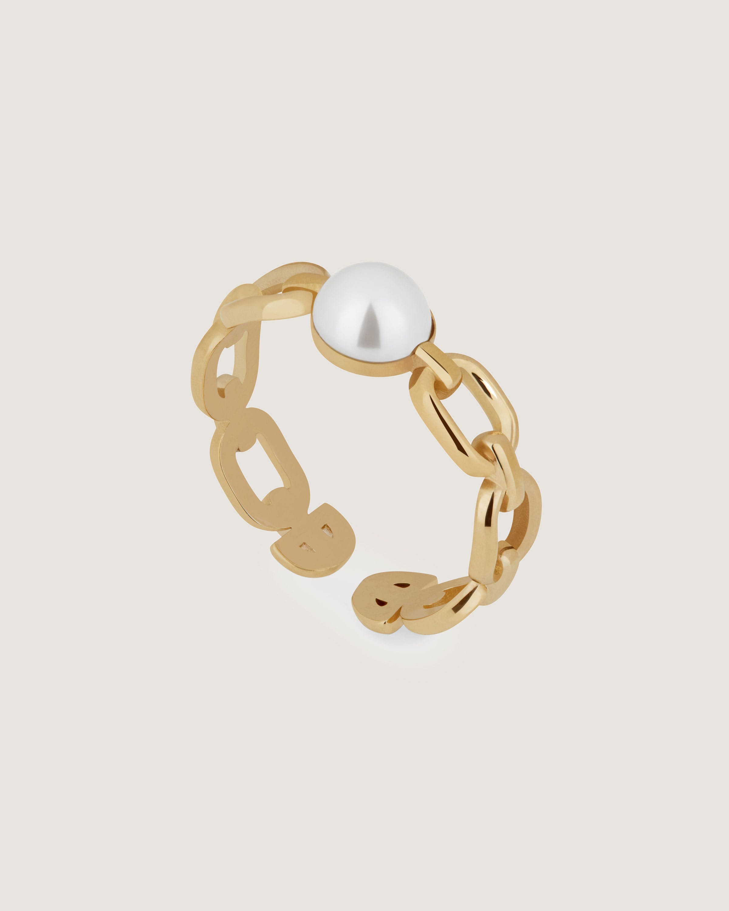 A gold ring with a pearl in the middle