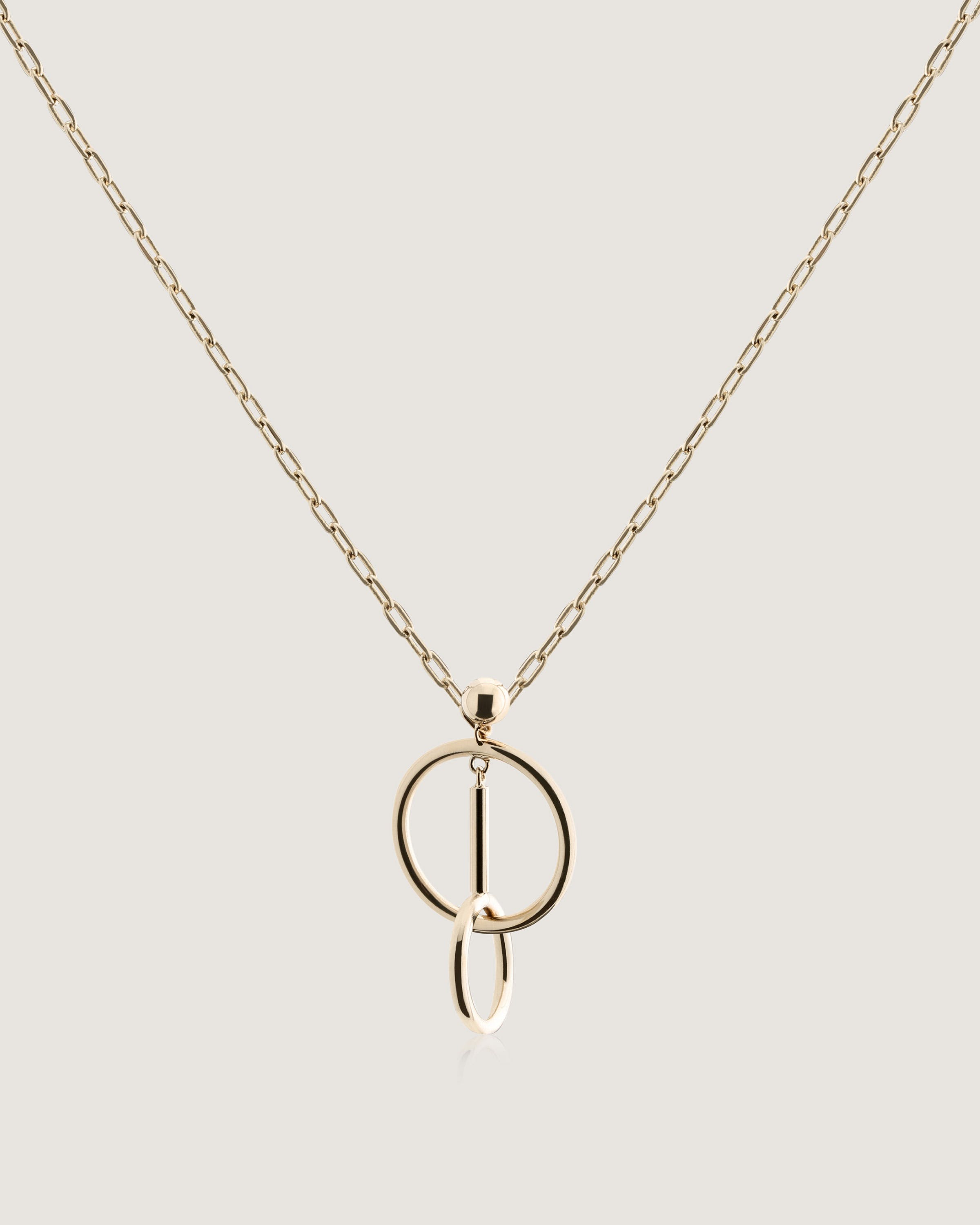 A gold necklace with a letter on it