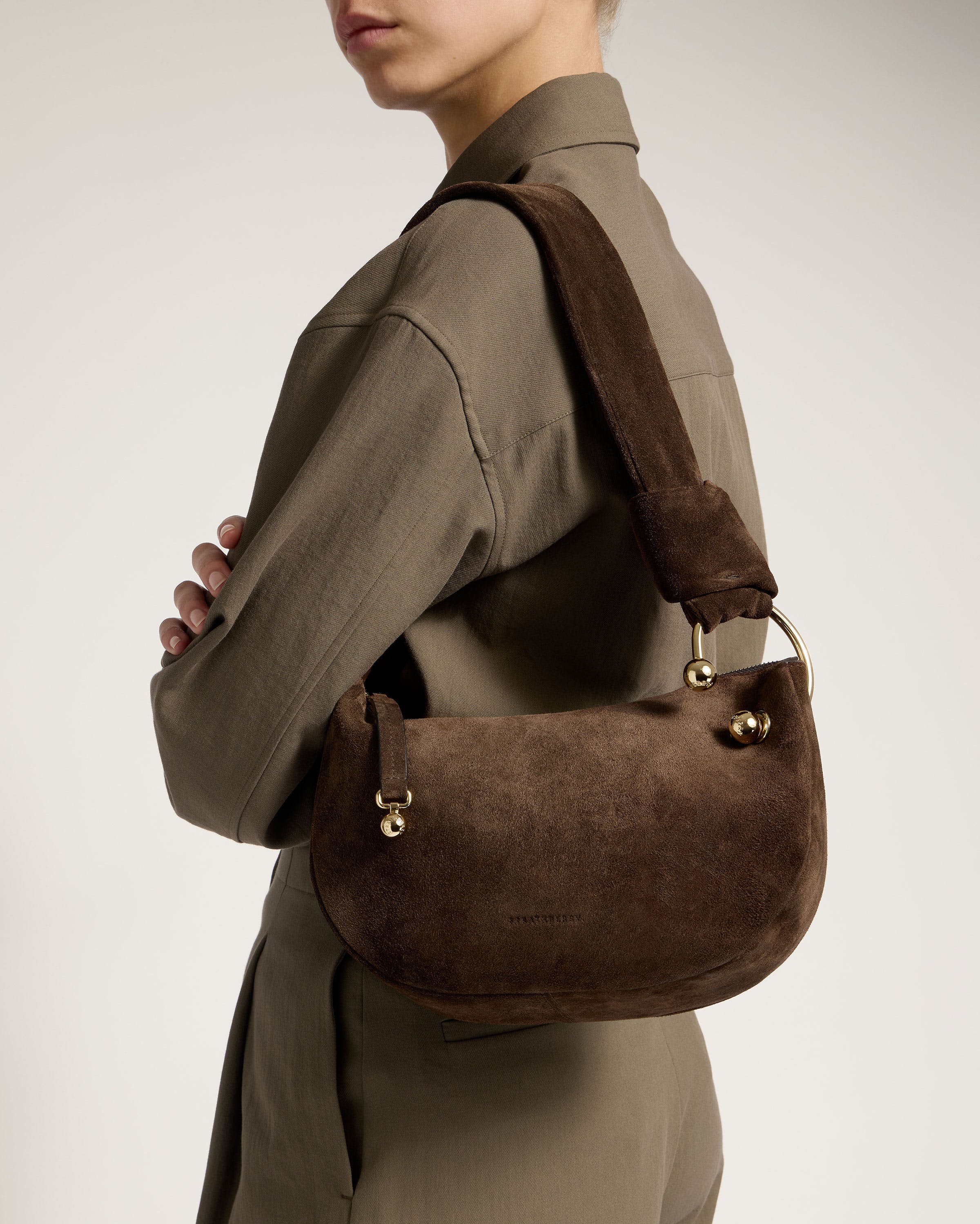 A woman with a brown purse on her shoulder