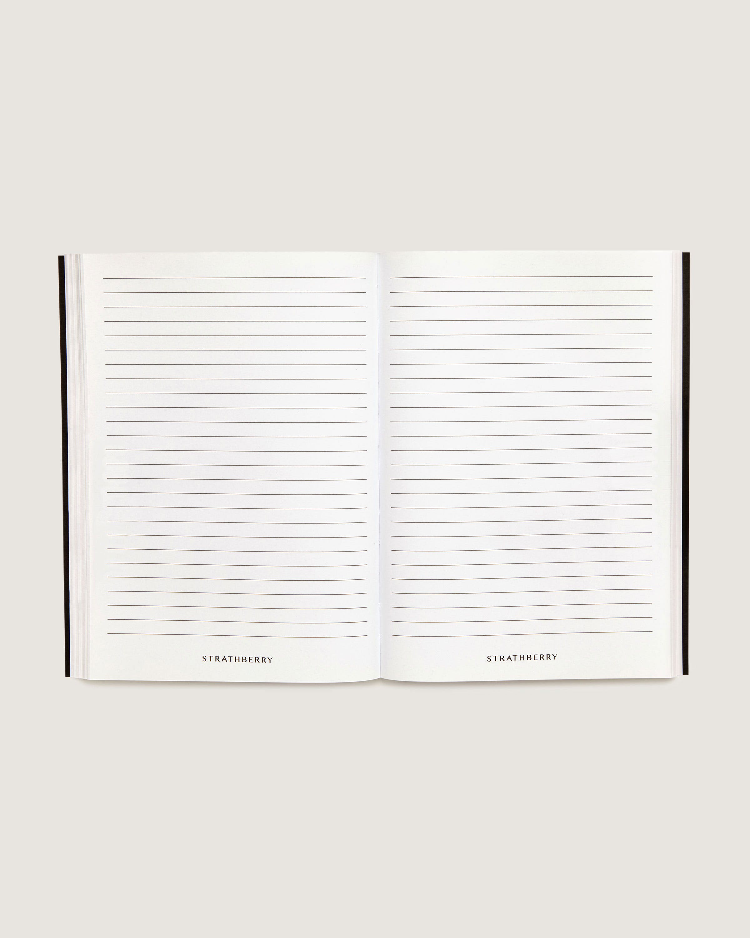 An open notebook with lined pages on a white background