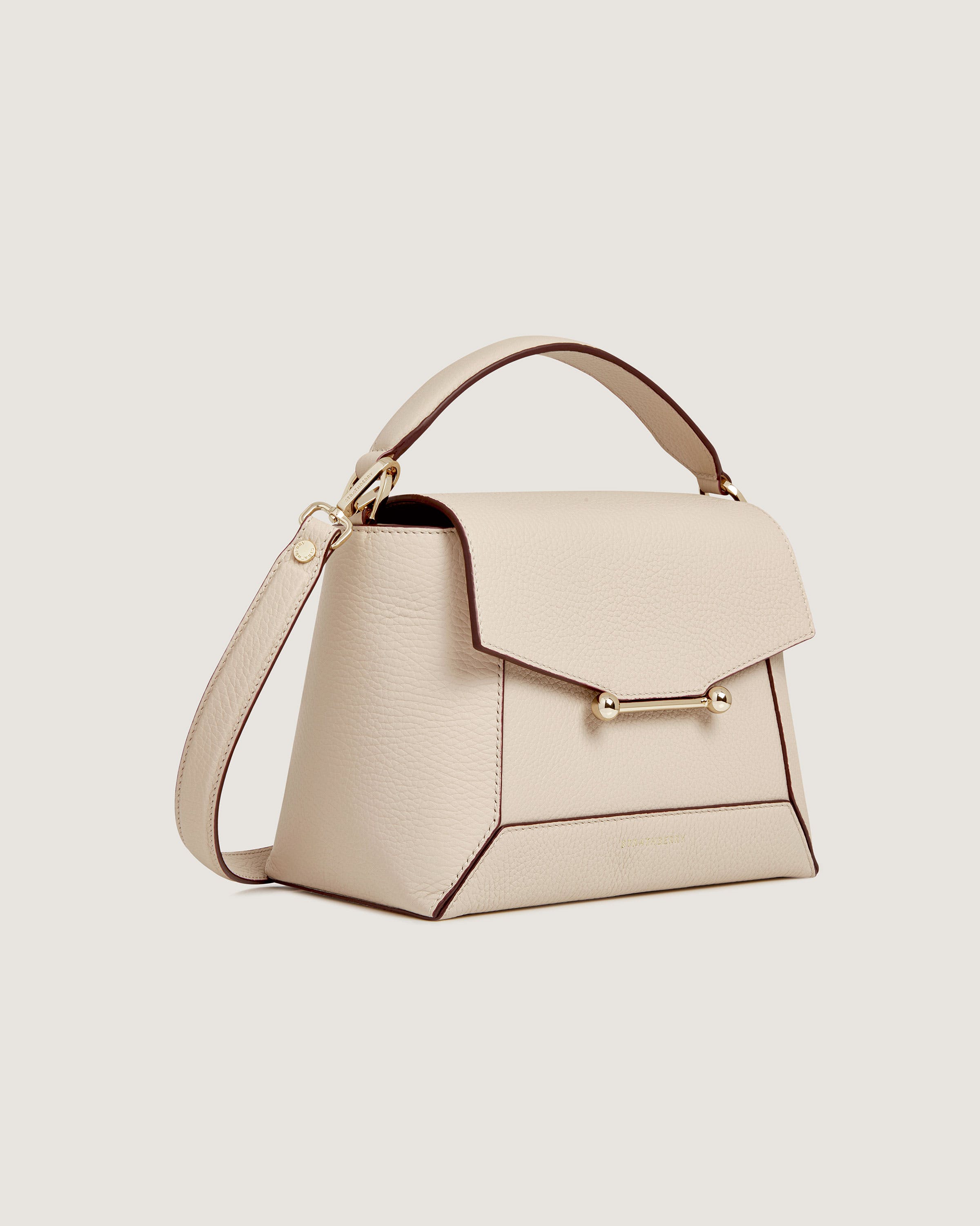 A white handbag with a handle on a white background