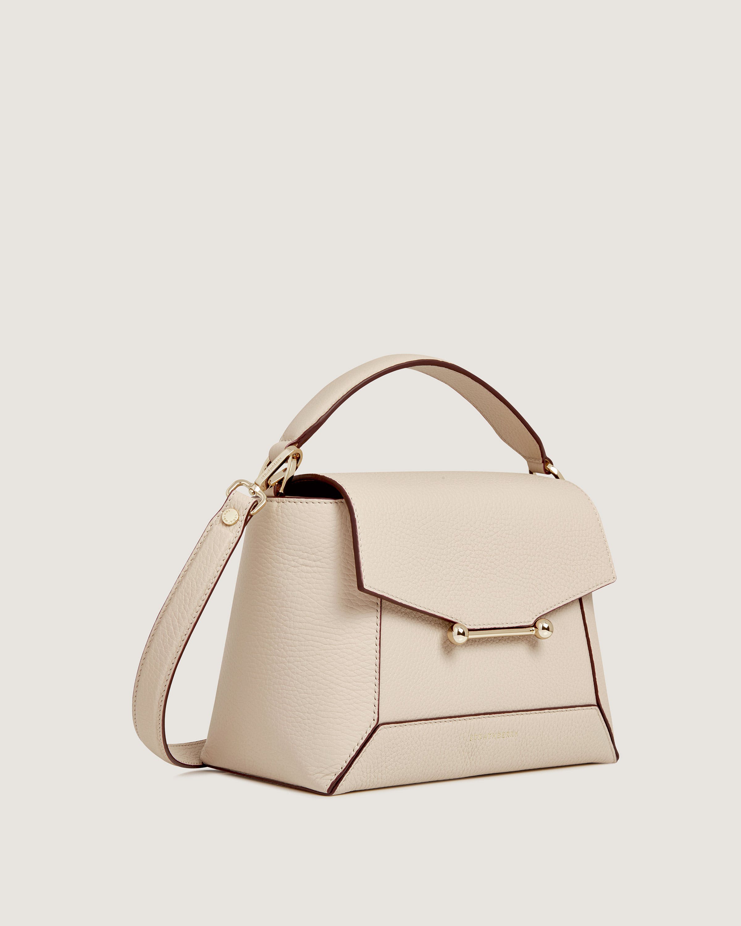 A white handbag with a handle on a white background