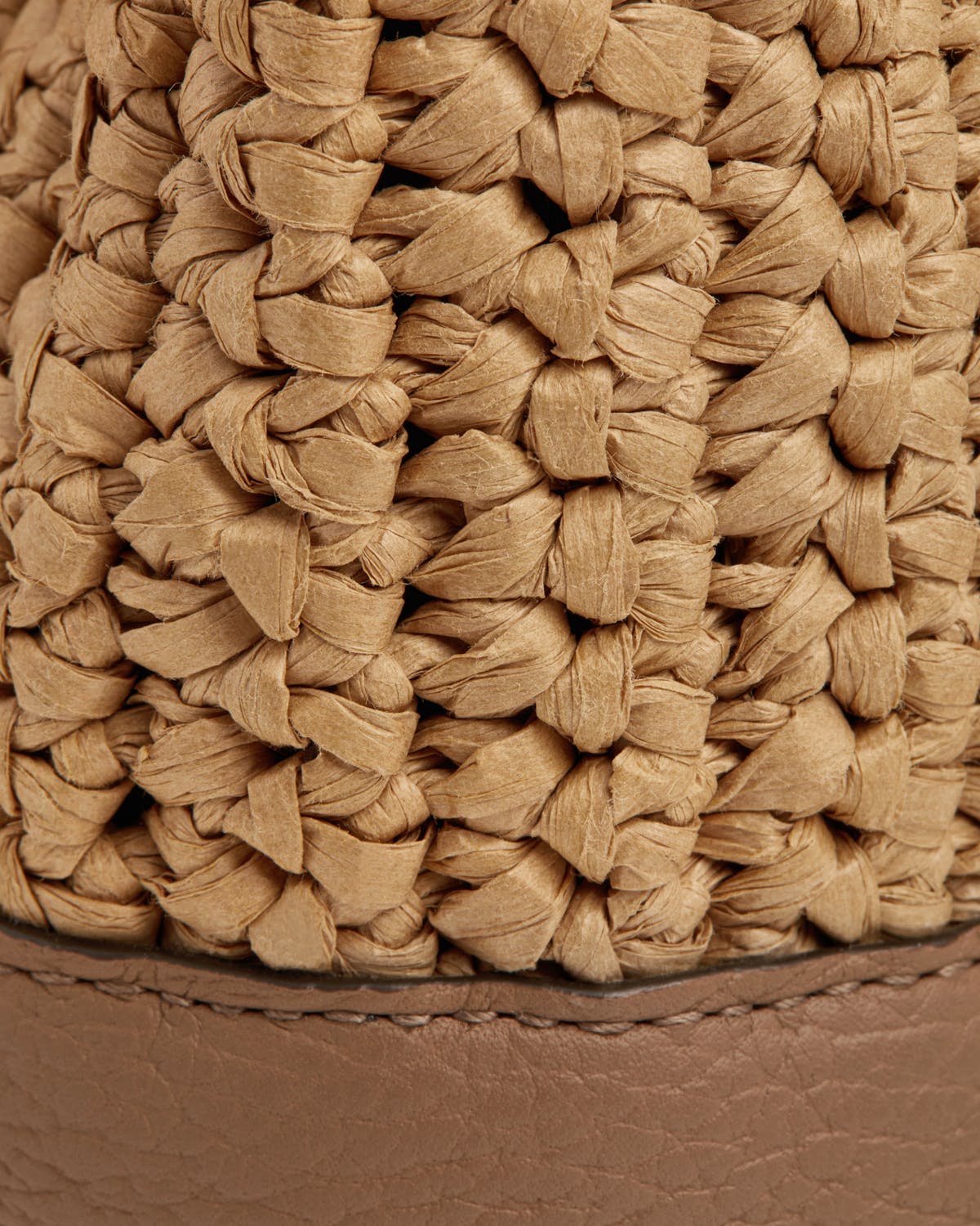 Close-up of Osette raffia weave and clay leather base.
