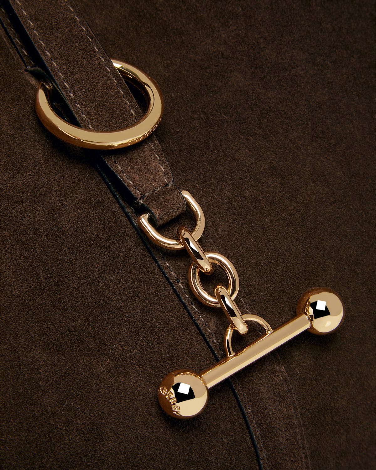 Chocolate suede strap with gold rings, chain links and toggle hardware.