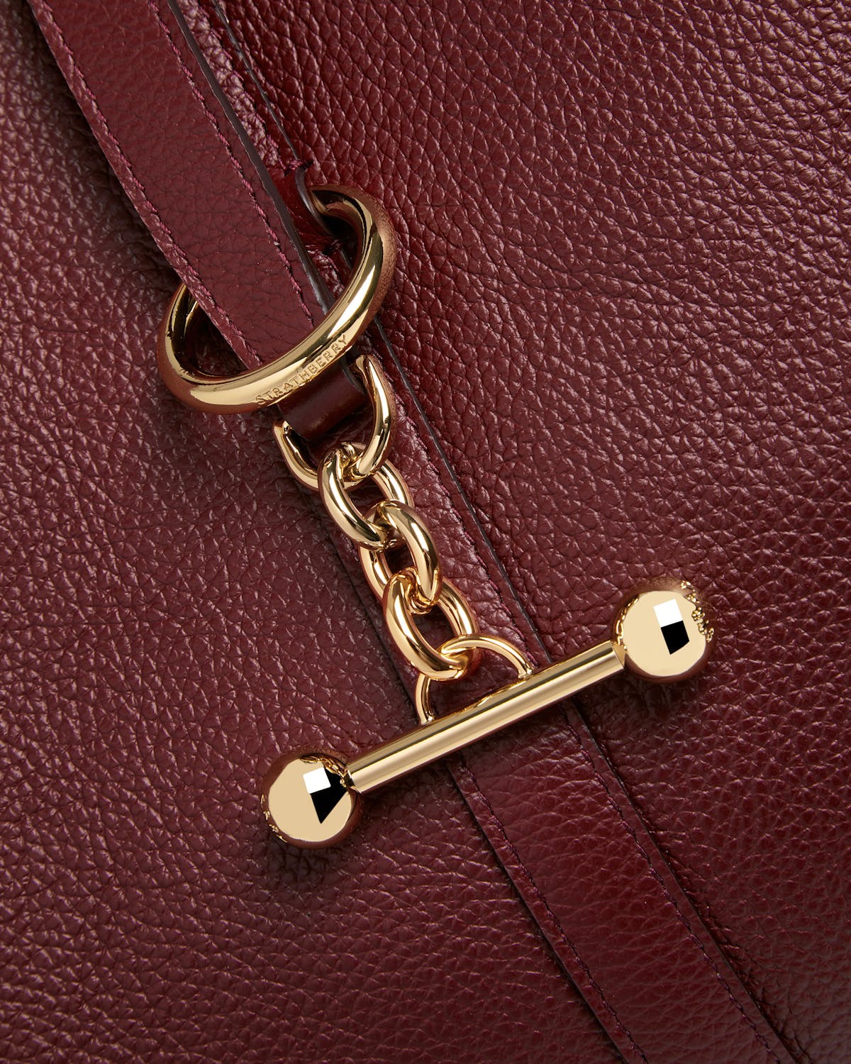 Strathberry Kite Hobo in oxblood pebbled leather with gold chain and T-bar