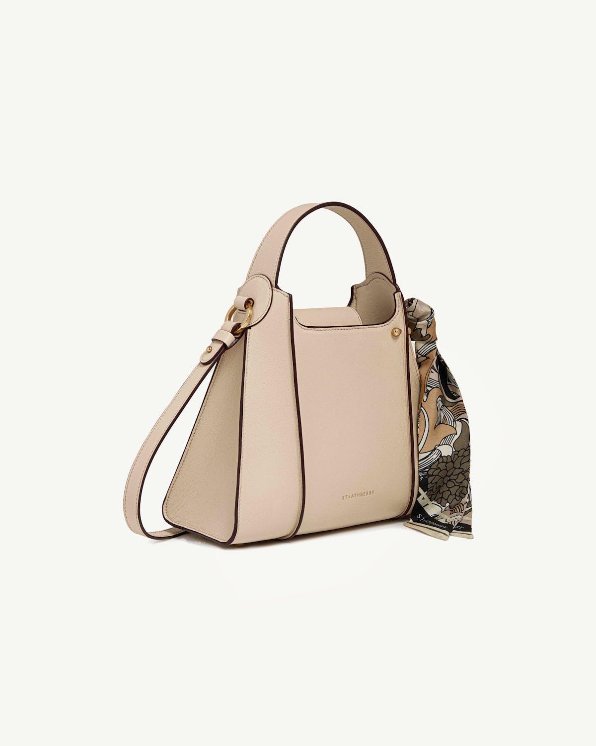Strathberry Arkshell tote in oat with top handle and patterned scarf.