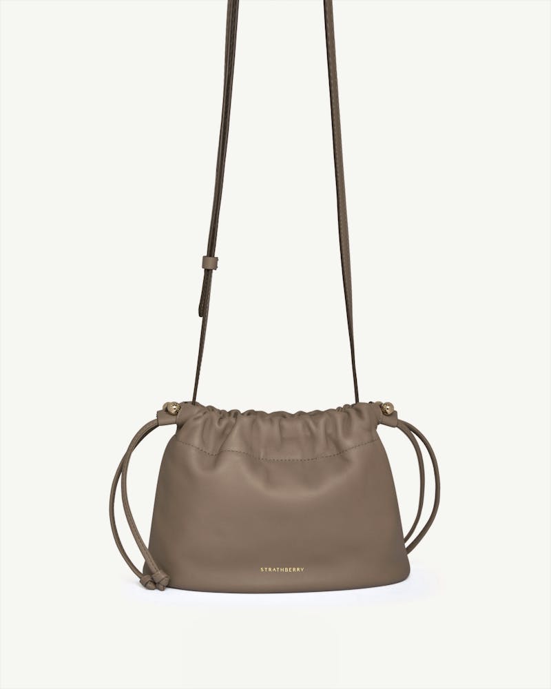 Strathberry Charlotte drawstring bag in taupe with long shoulder strap