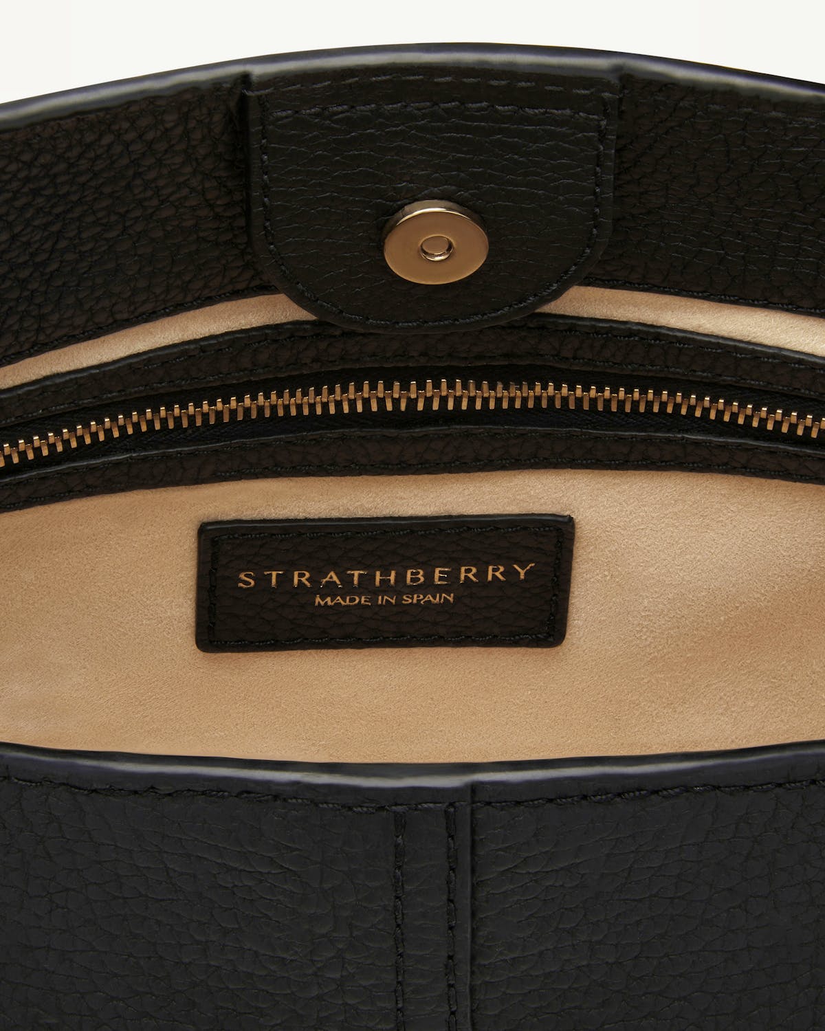 Strathberry Lana Hobo black interior showing zip pocket and logo label