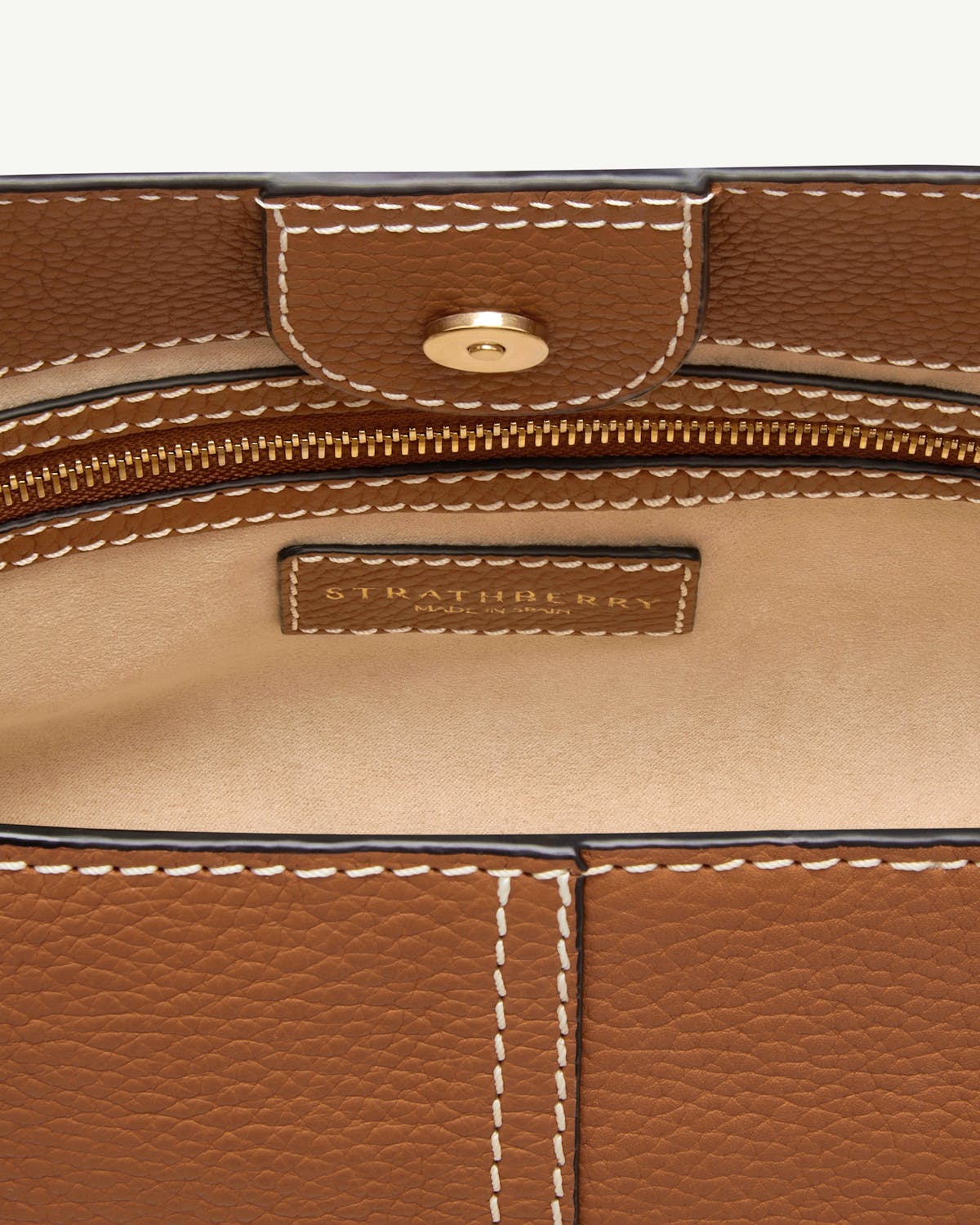 Interior view of tan Strathberry Lana Hobo showing zipper and label
