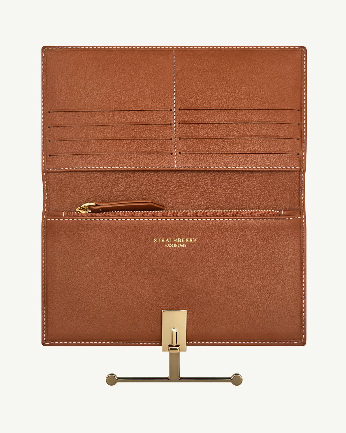 Open chestnut leather large wallet with vanilla stitching, card slots, zip pocket, Strathberry logo.