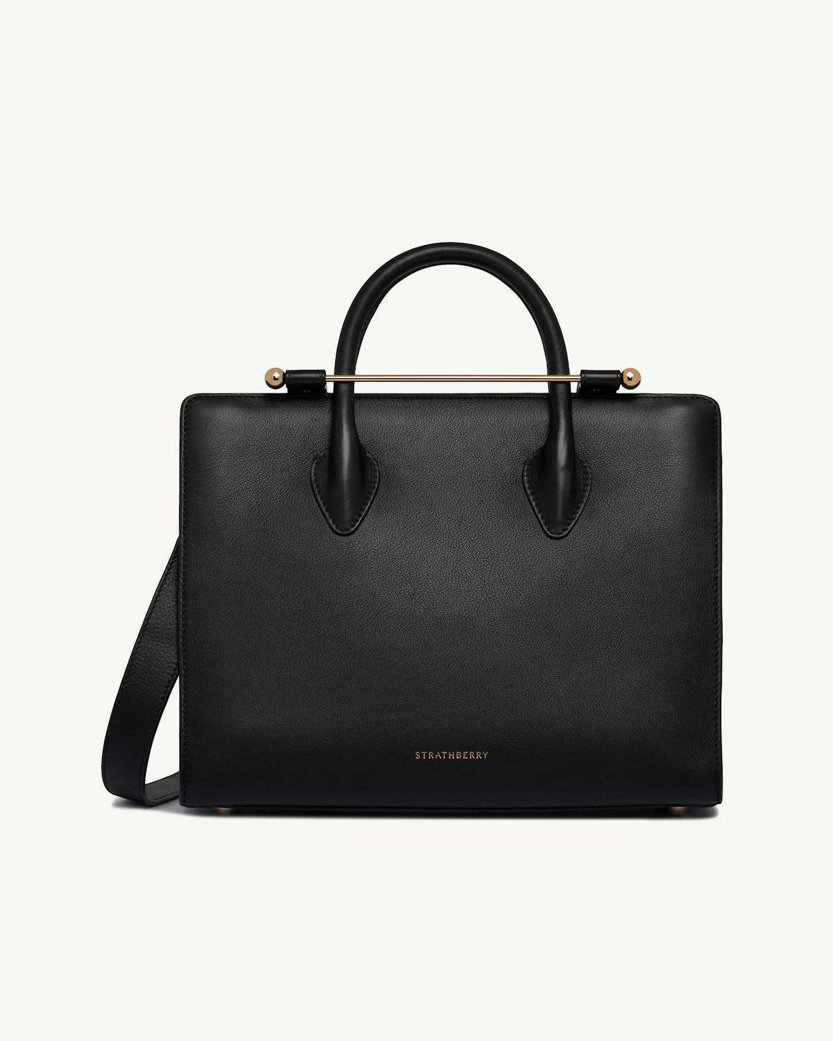 Strathberry black midi tote with top handles and gold bar hardware.
