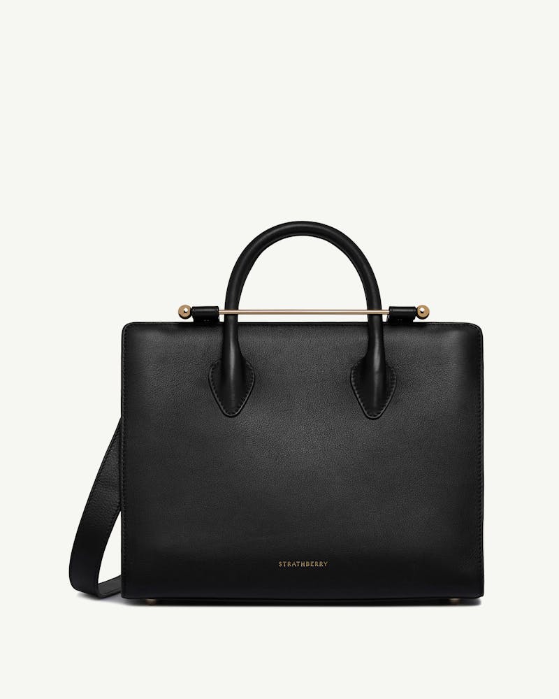 Black Strathberry midi tote with top handles and gold bar hardware.