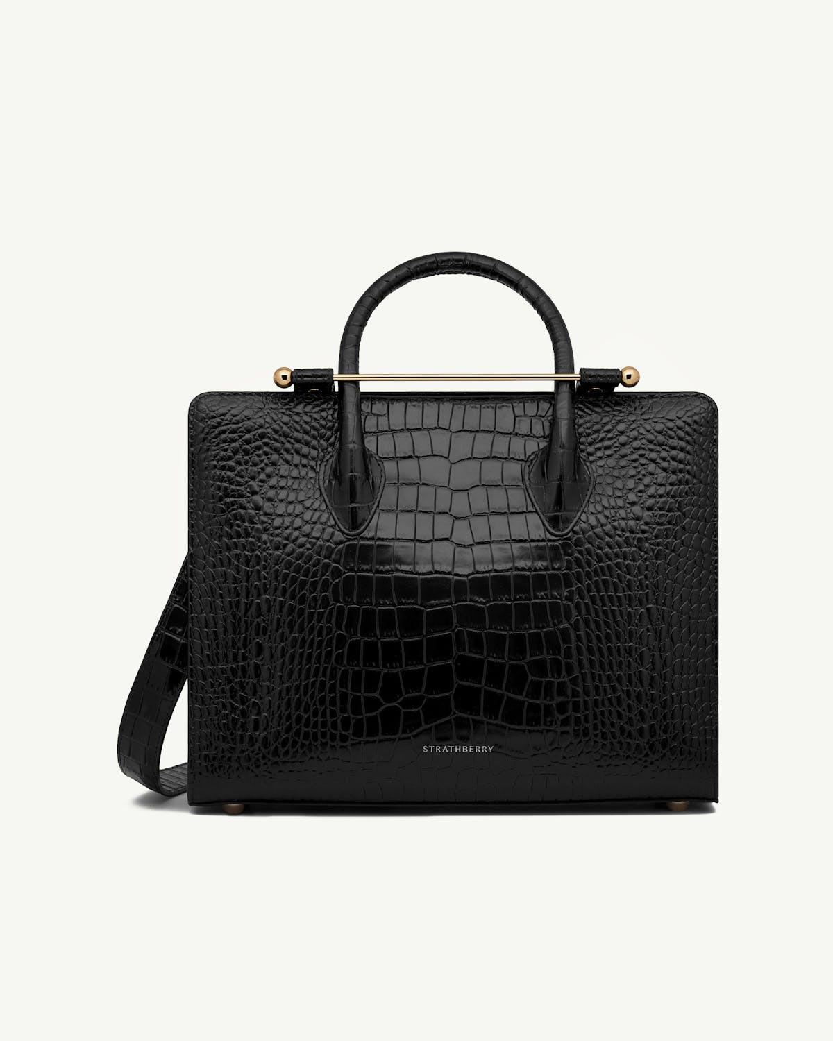 Strathberry midi tote in black croc leather with top handles and shoulder strap.
