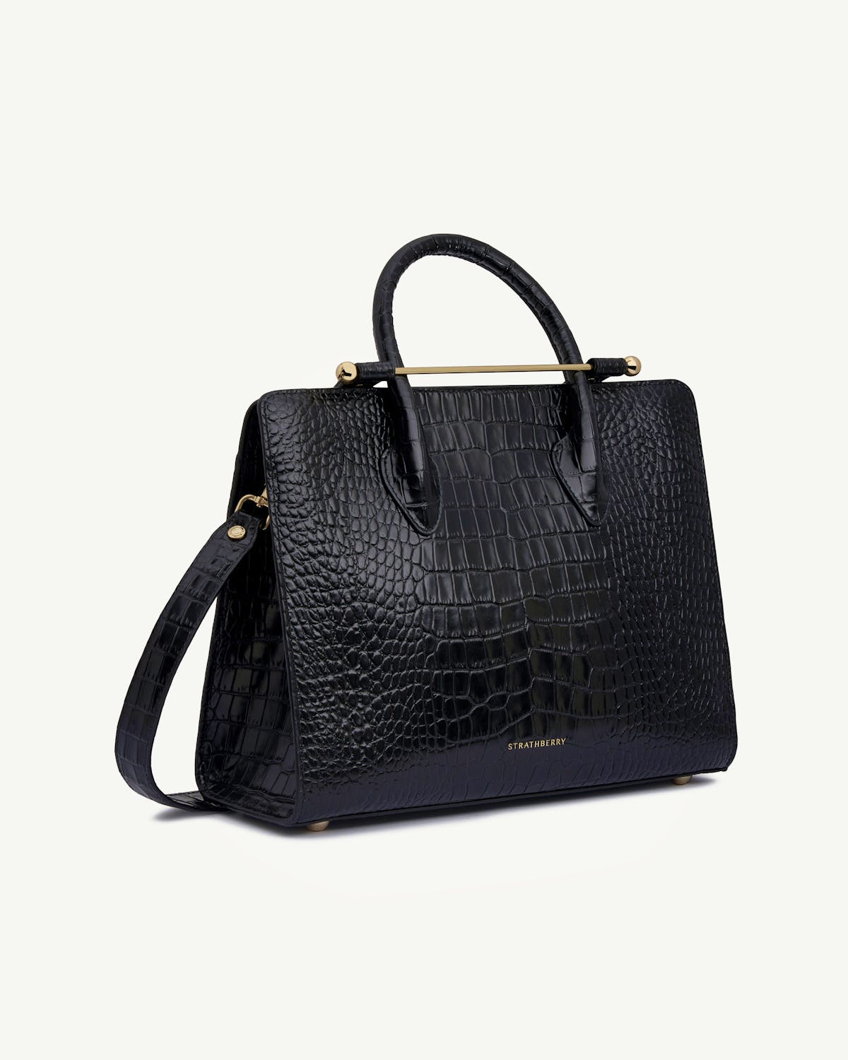 Strathberry black croc midi tote with top handles, shoulder strap, gold bar.