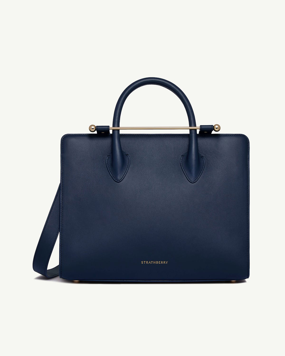Strathberry midi tote in marine blue, front view with top handle and strap.