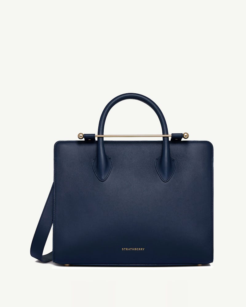 Strathberry midi tote in marine blue with top handles and gold bar