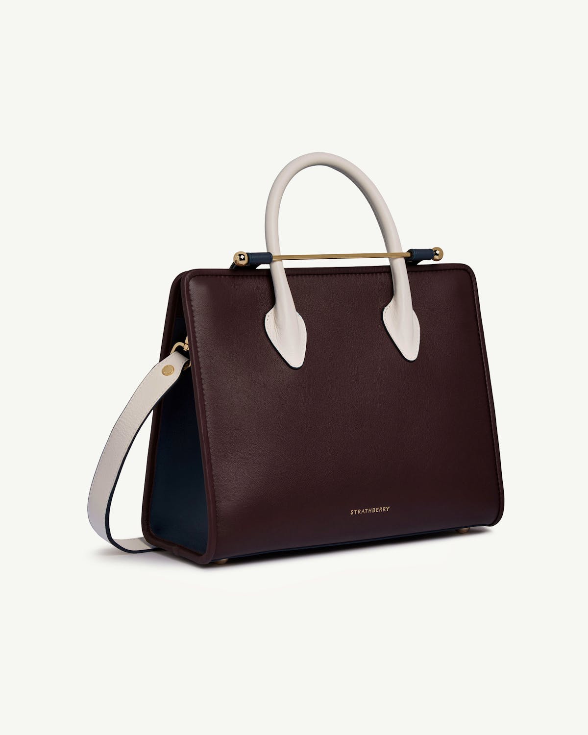 Strathberry midi tote in burgundy with navy interior and vanilla handles