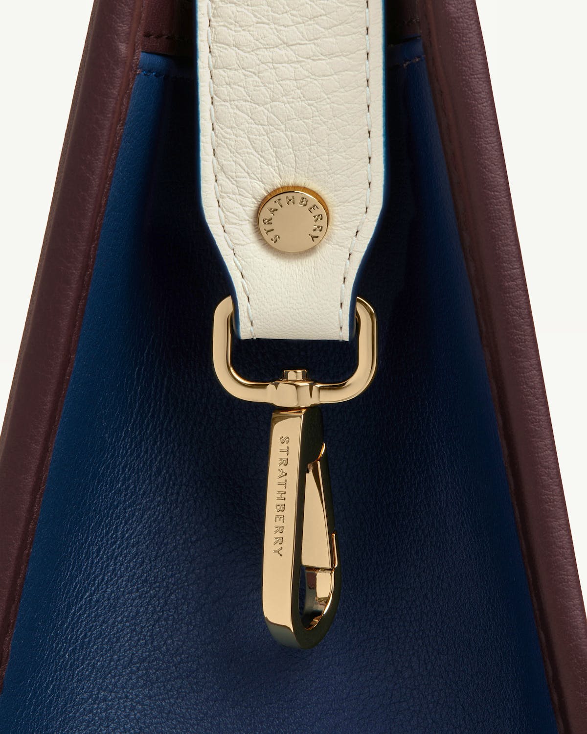 Close-up of Strathberry midi tote side strap and gold clasp