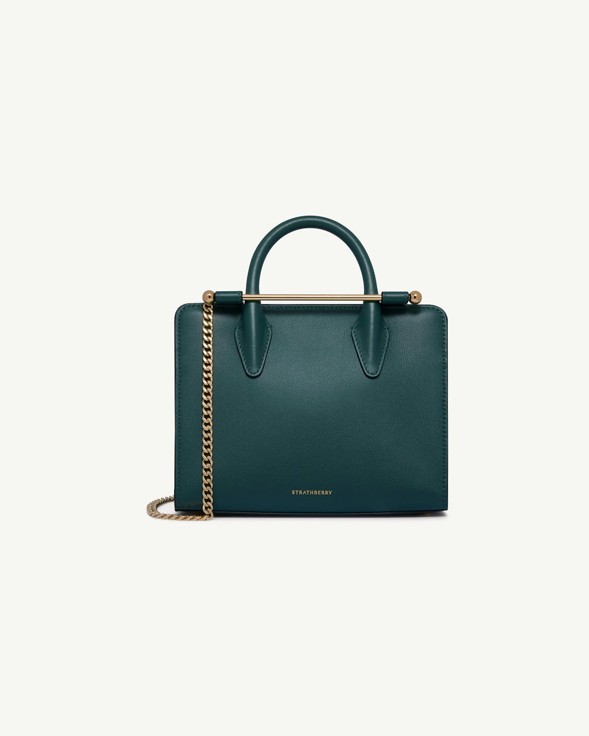 Bottle green Strathberry mini tote with gold chain and bar handle.