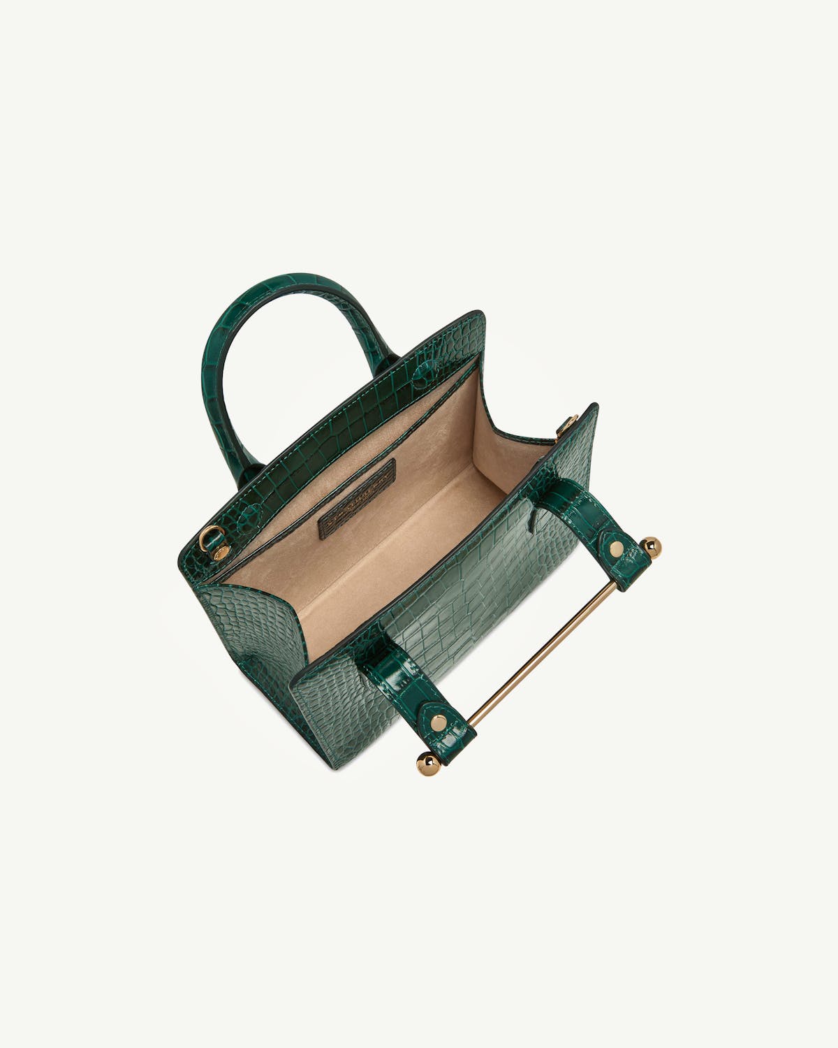 Green croc-effect mini tote open, showing beige interior and gold bar handle