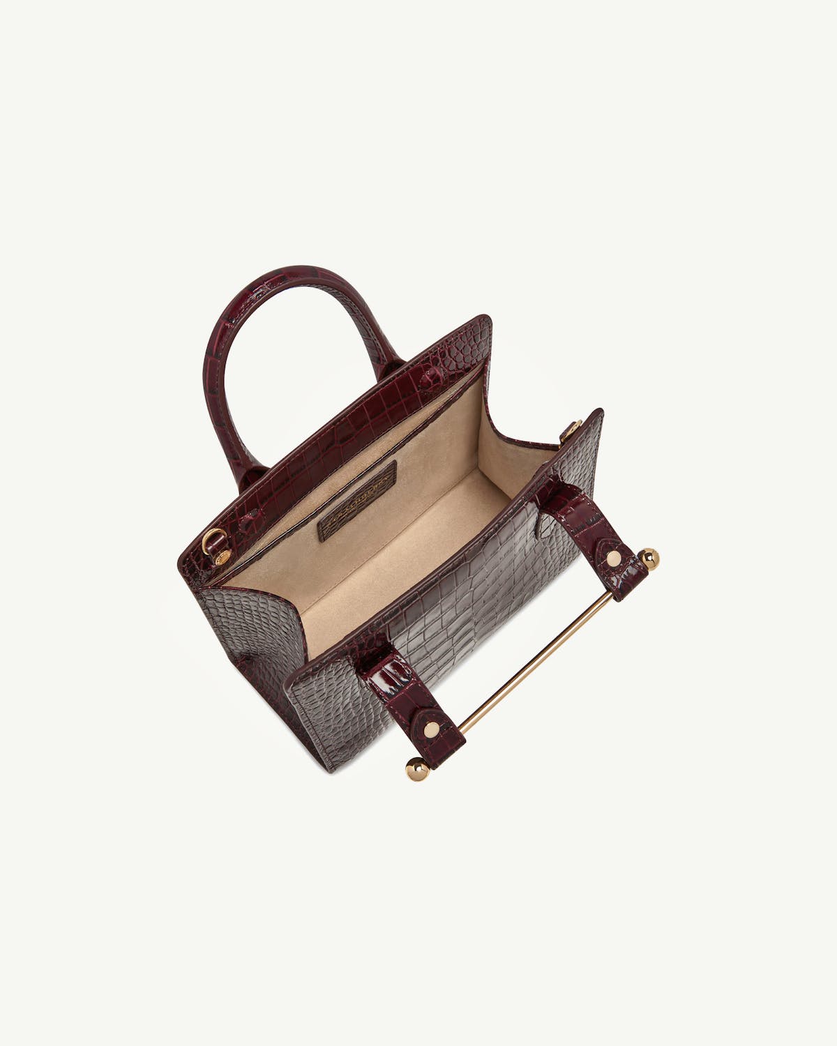 Mini croc tote with open top showing beige interior and gold bar handle