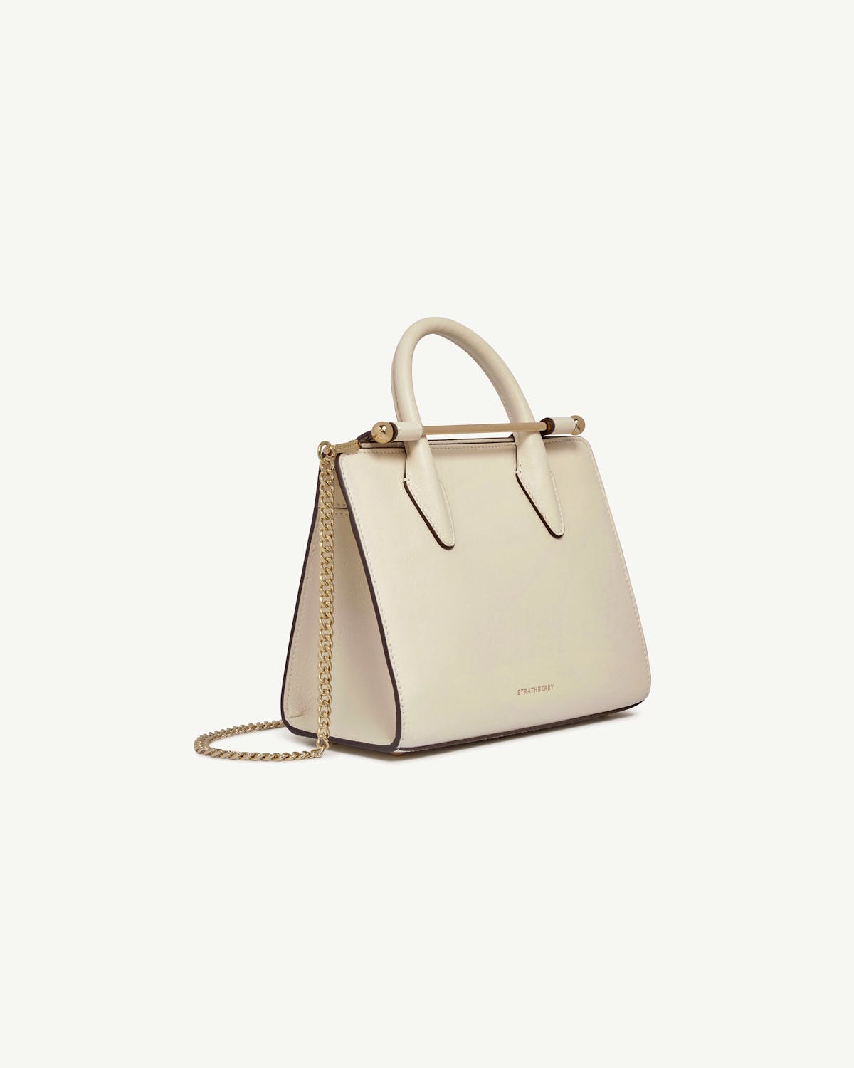 Strathberry mini tote in vanilla with top handles and gold chain strap