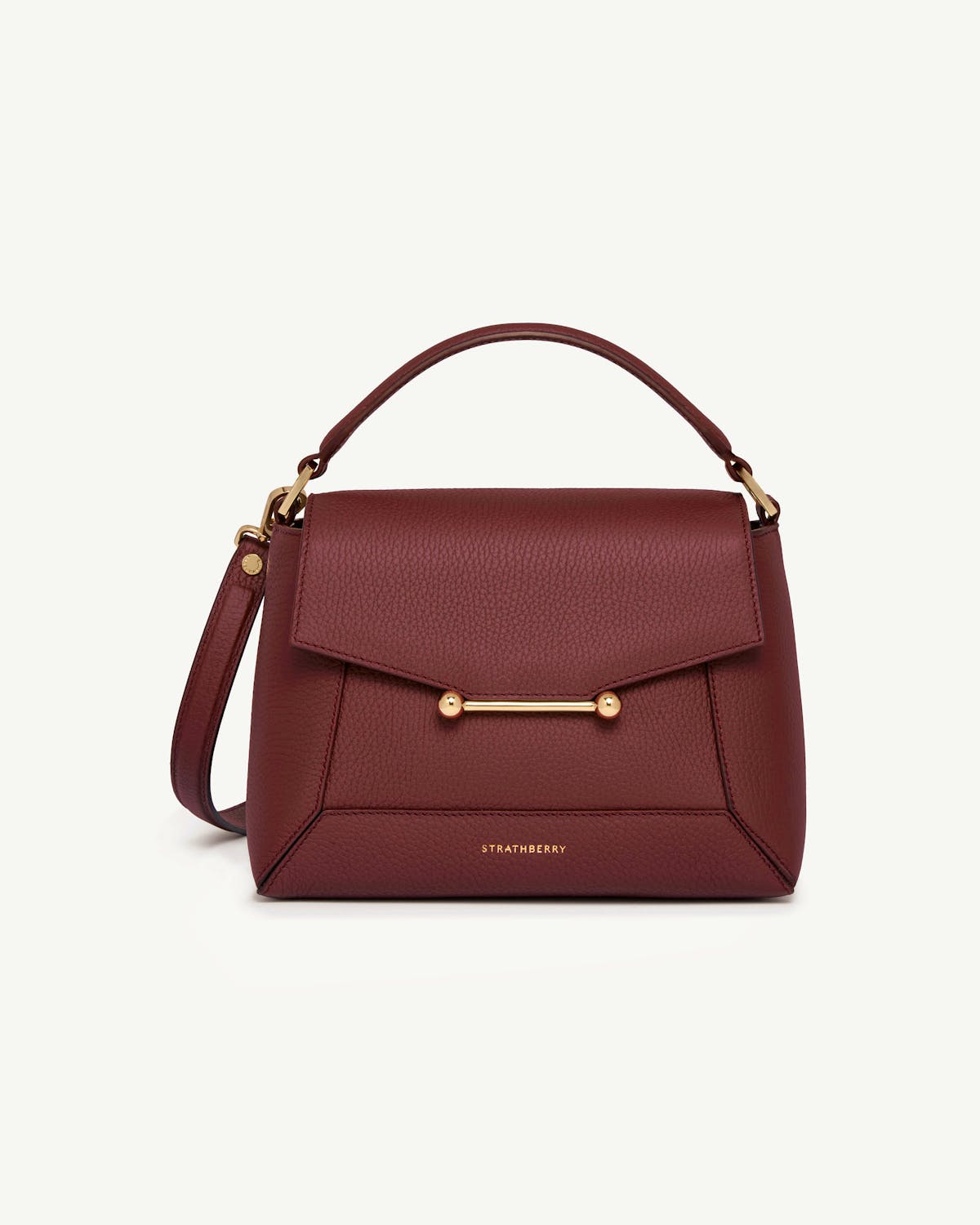 Oxblood mosaic bag with top handle and gold bar detail, Strathberry logo.