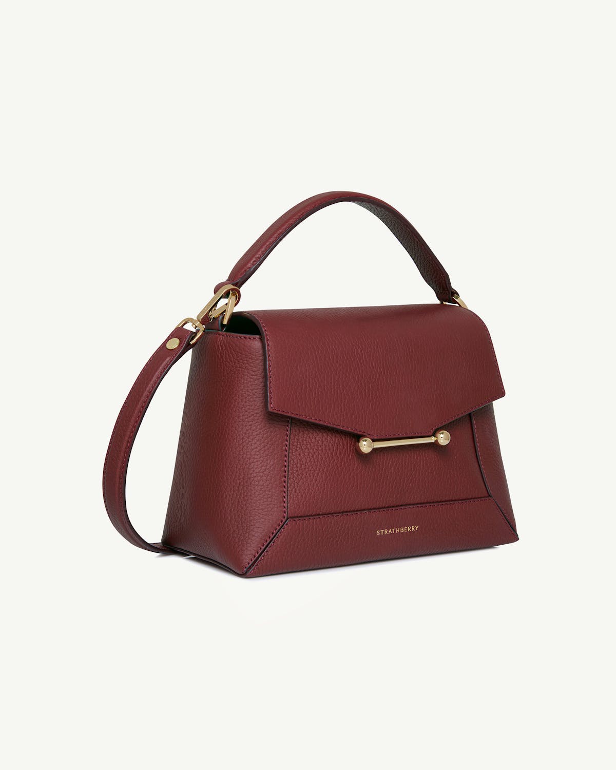 Strathberry oxblood mosaic bag with top handle, detachable shoulder strap and gold bar fastening.