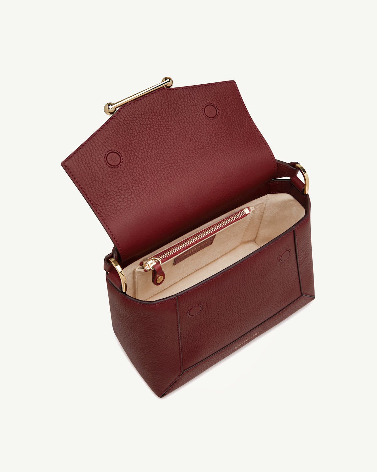 Oxblood leather mosaic bag open showing beige suede interior and gold hardware.