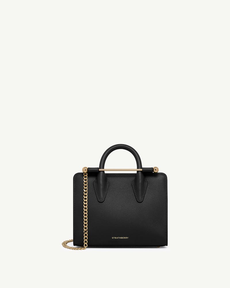 Strathberry nano tote in black with gold bar and chain strap.