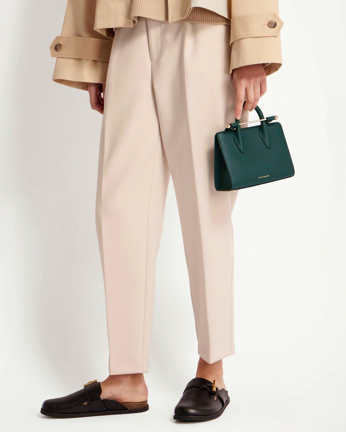 Strathberry bottle green nano tote held at model's hip