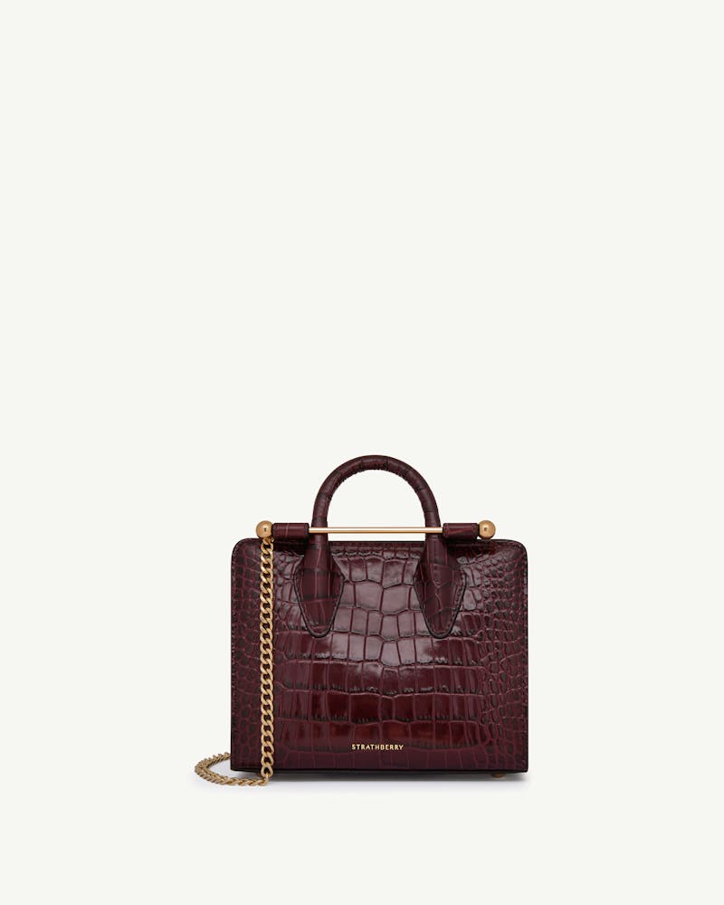 Strathberry nano tote in croc-embossed burgundy with top handle and chain