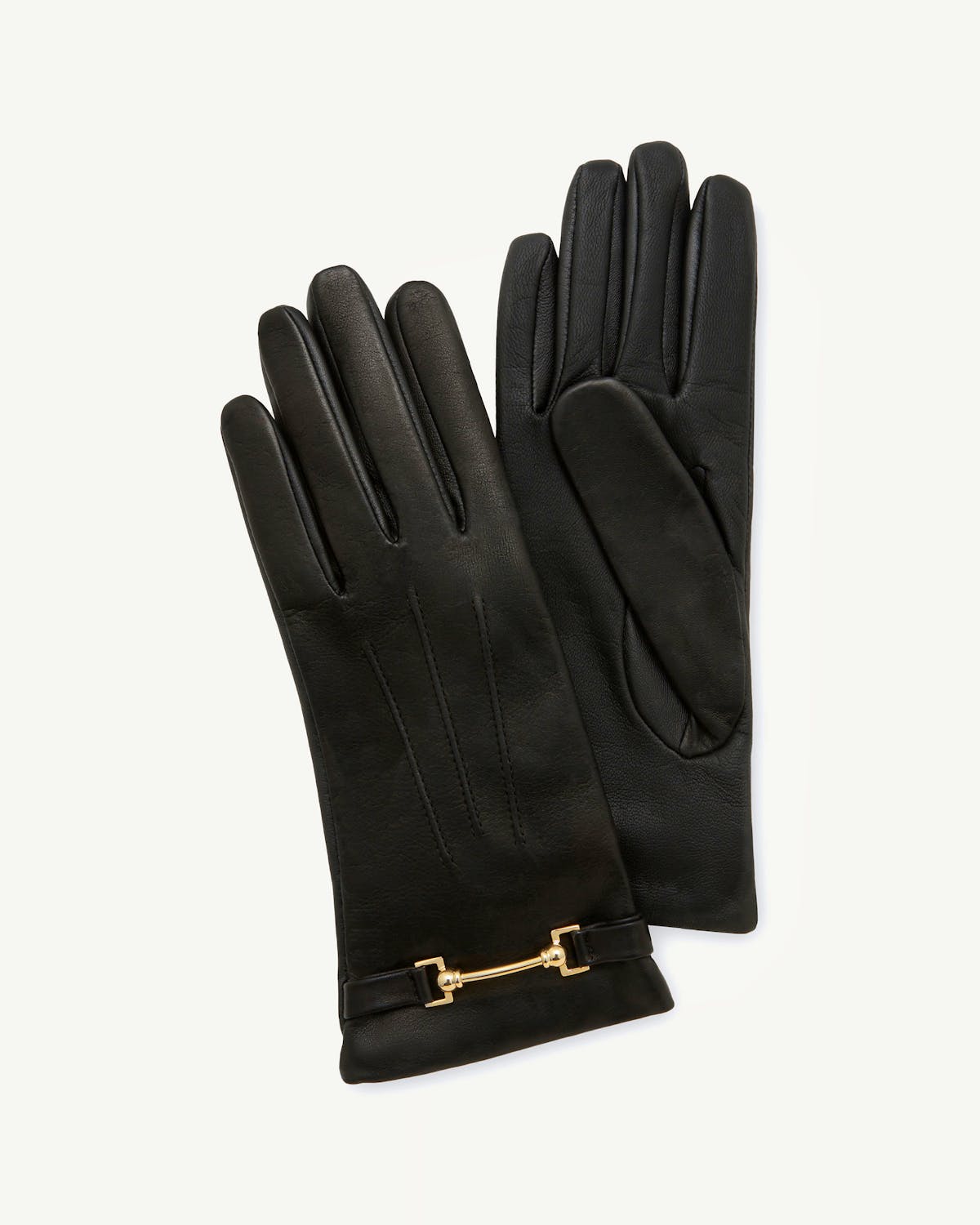 Pair of black leather gloves with gold horsebit detail, laid flat