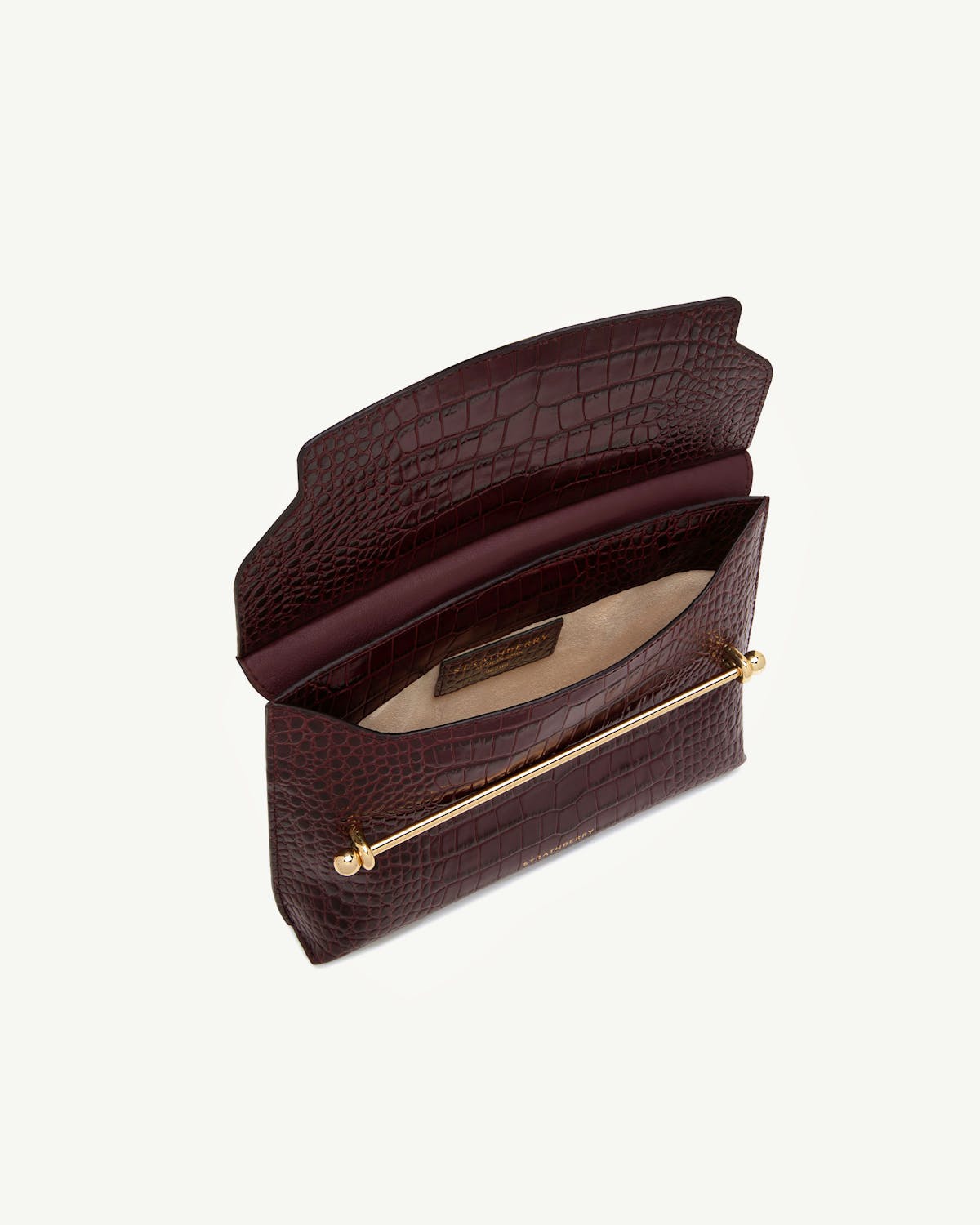 Croc leather stylist clutch open showing interior and gold bar