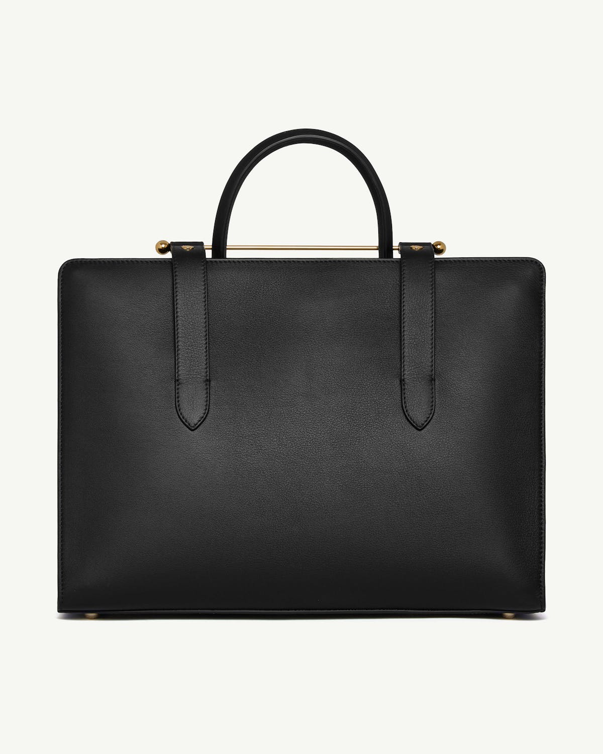 Black structured tote with top handles, gold bar detail and metal feet.